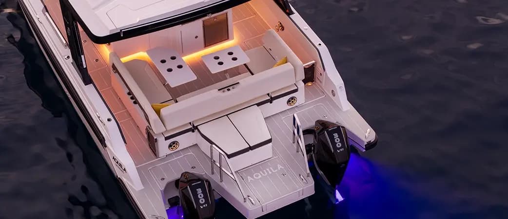Aquila 35 Sport with its lights on at dusk