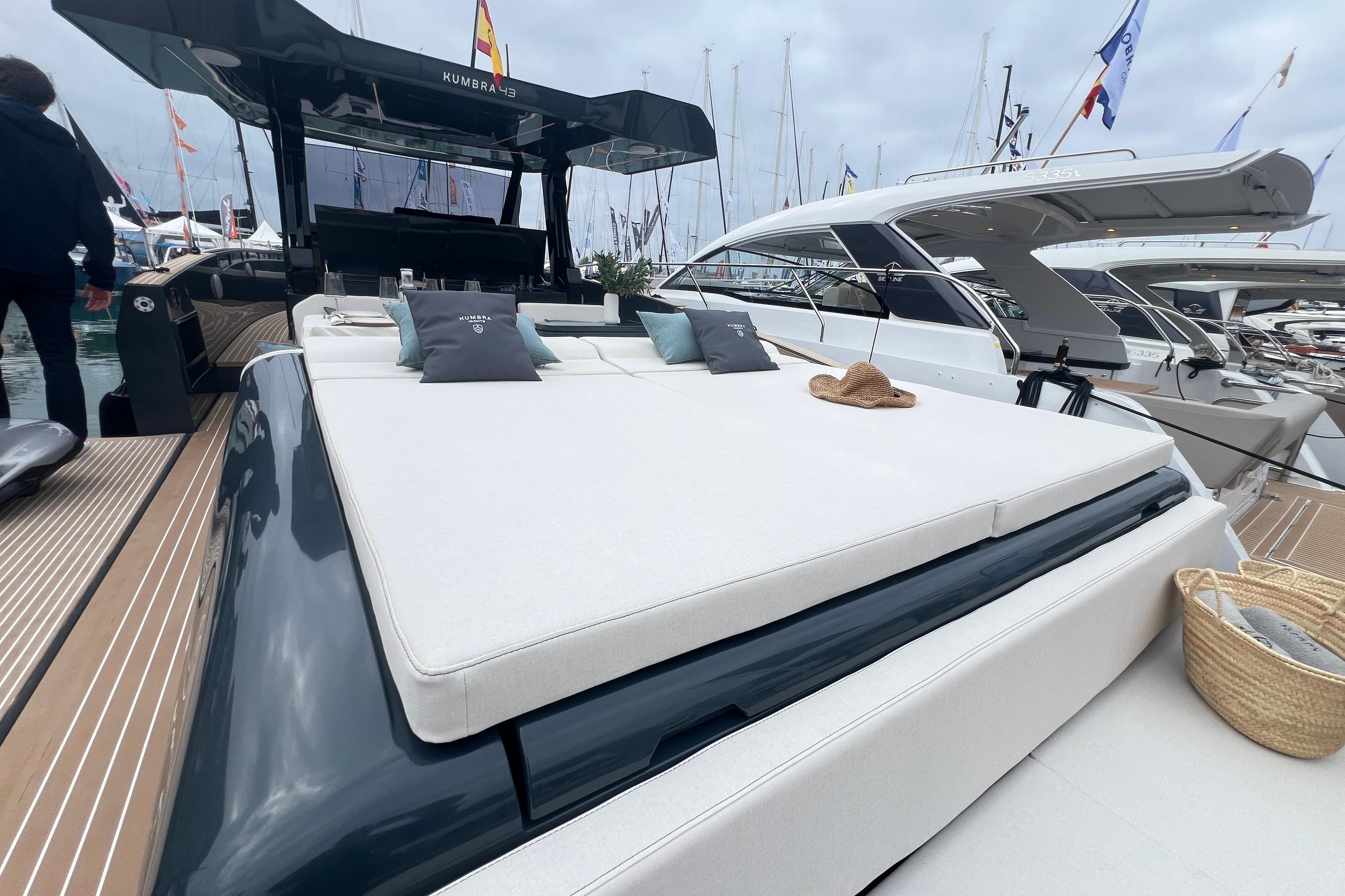 Luxurious 2026 Kumbra 43 yacht with spacious sun deck at marina.
