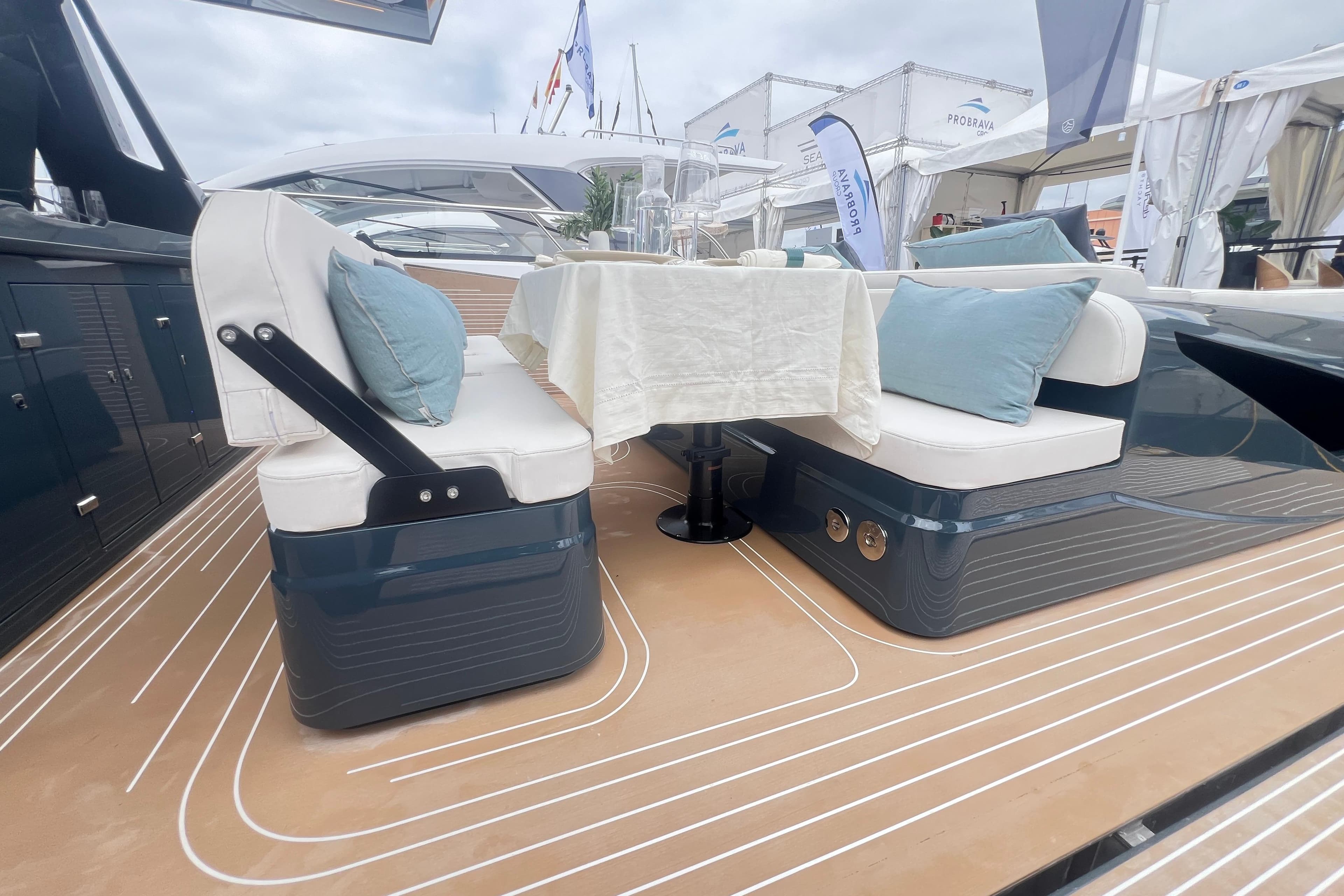 Luxurious seating area on 2026 Kumbra 43 yacht with elegant cushions and table setup.