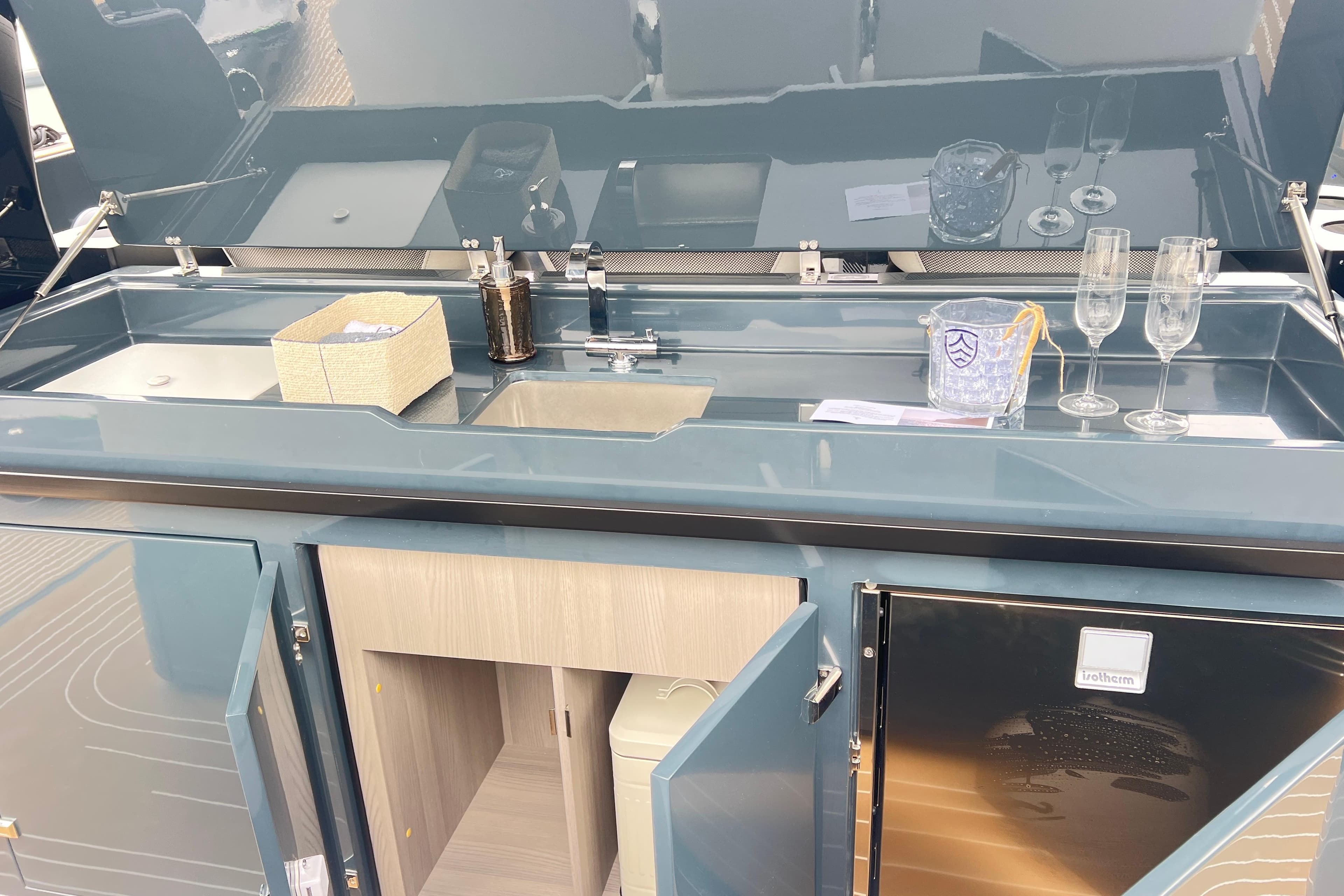 Modern Kumbra 43 yacht kitchenette with sink, storage, and glassware, 2026 model.