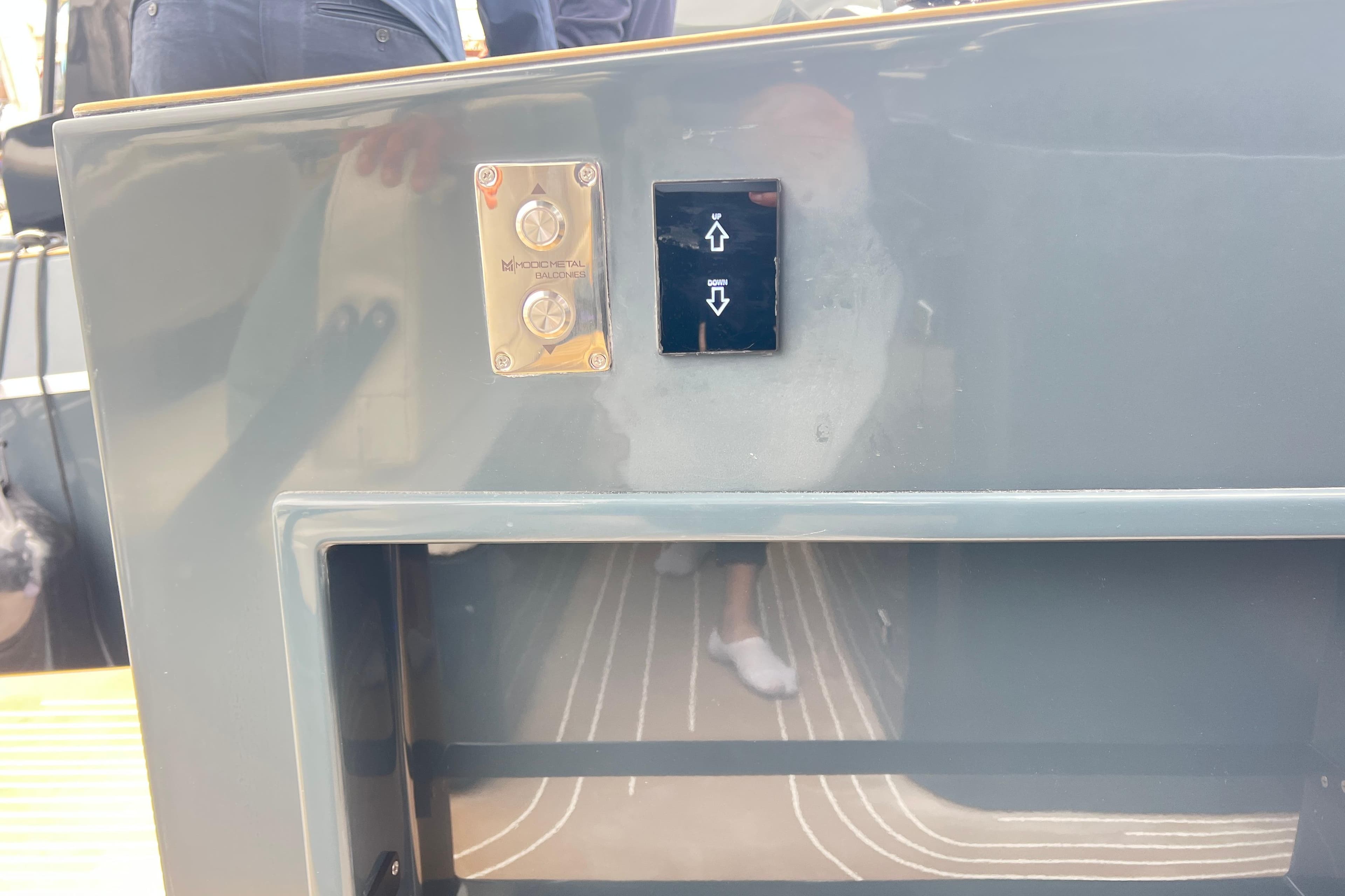 Control panel on a 2026 Kumbra 43 yacht, featuring up and down buttons.