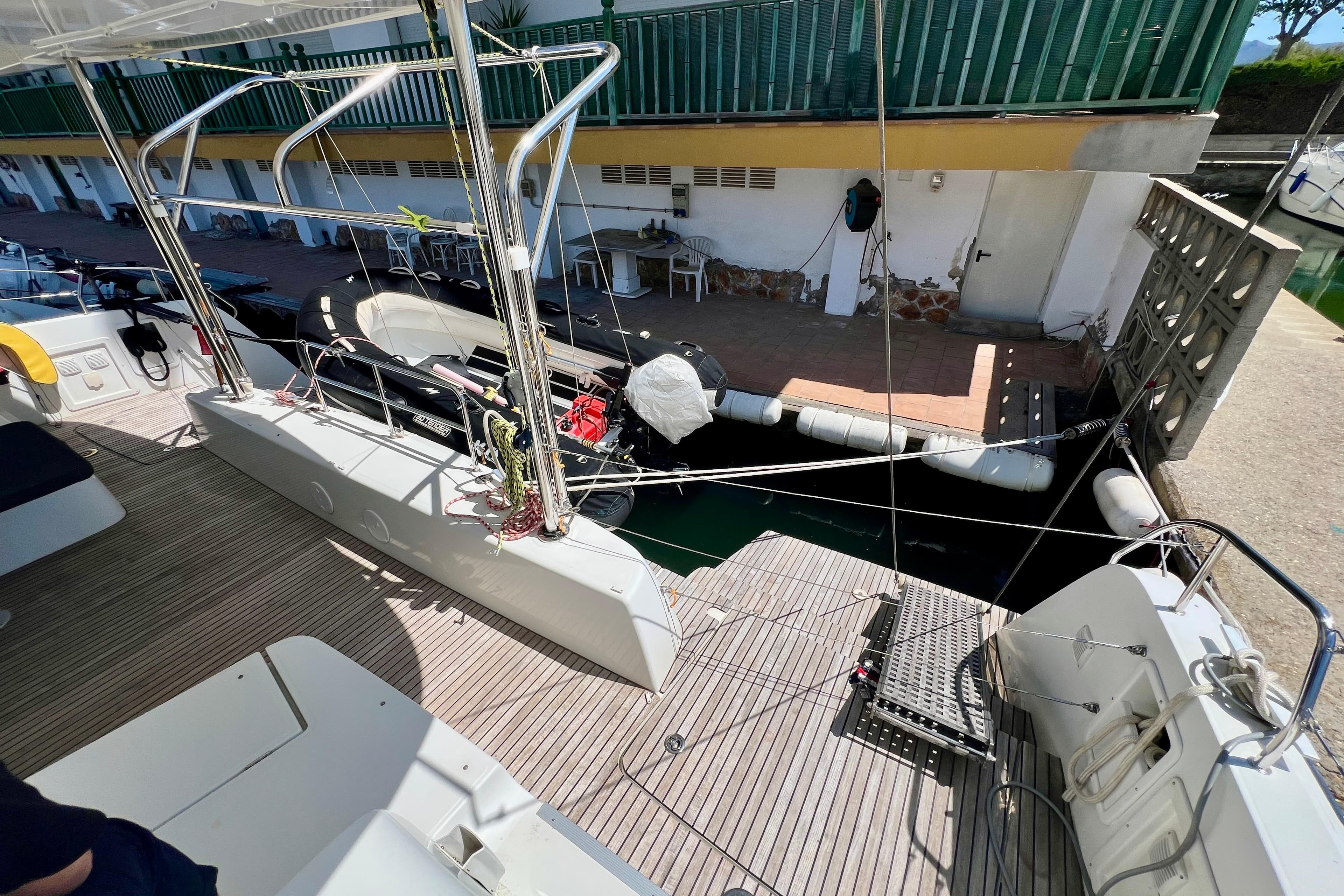 Lagoon 42 catamaran docked at marina, showcasing spacious deck and modern design, 2019 model.