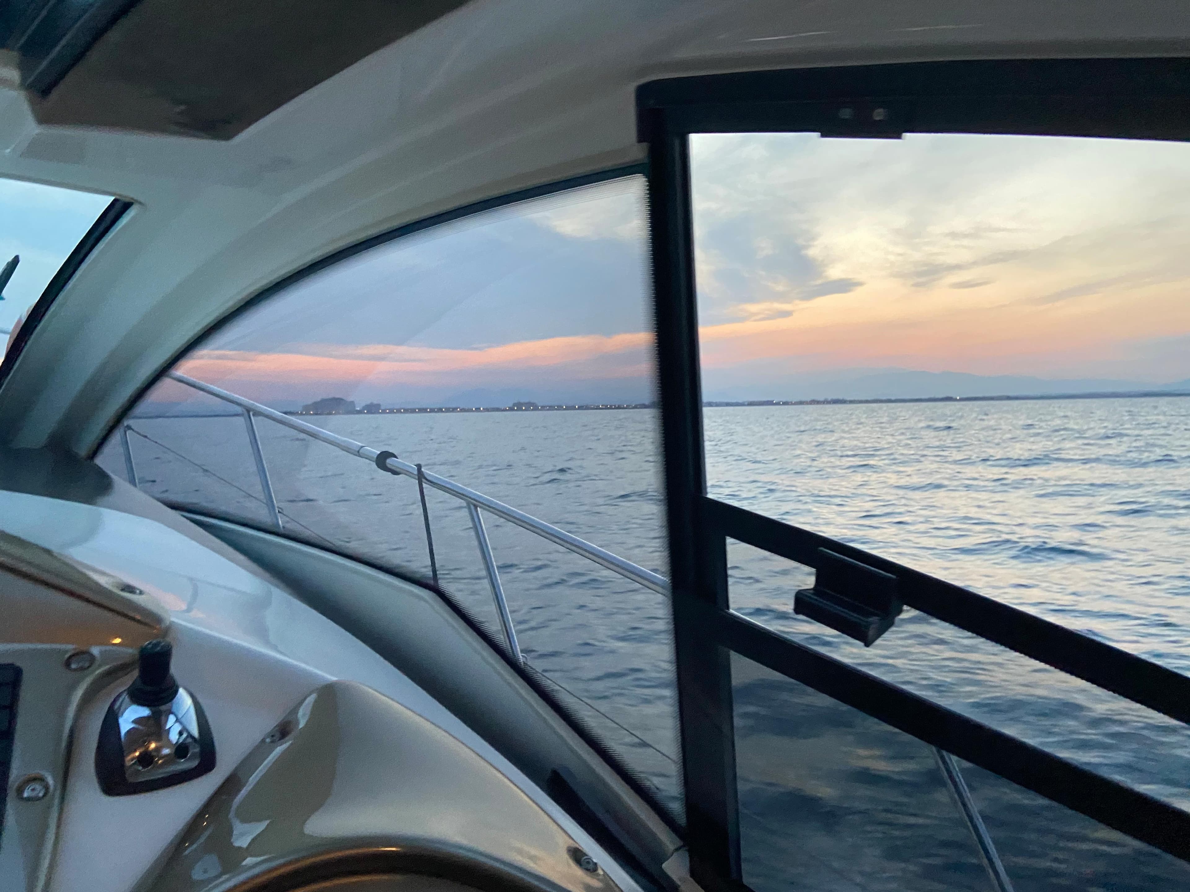 Cranchi M38 yacht interior view with sunset over the ocean, 2012 model.