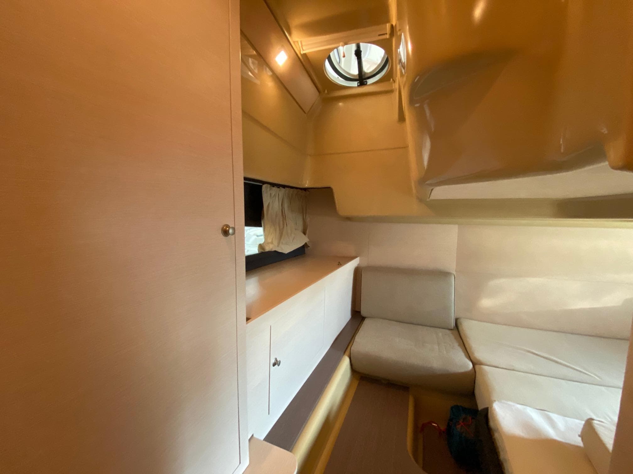 Interior of 2012 Cranchi M38 yacht cabin with seating and storage.