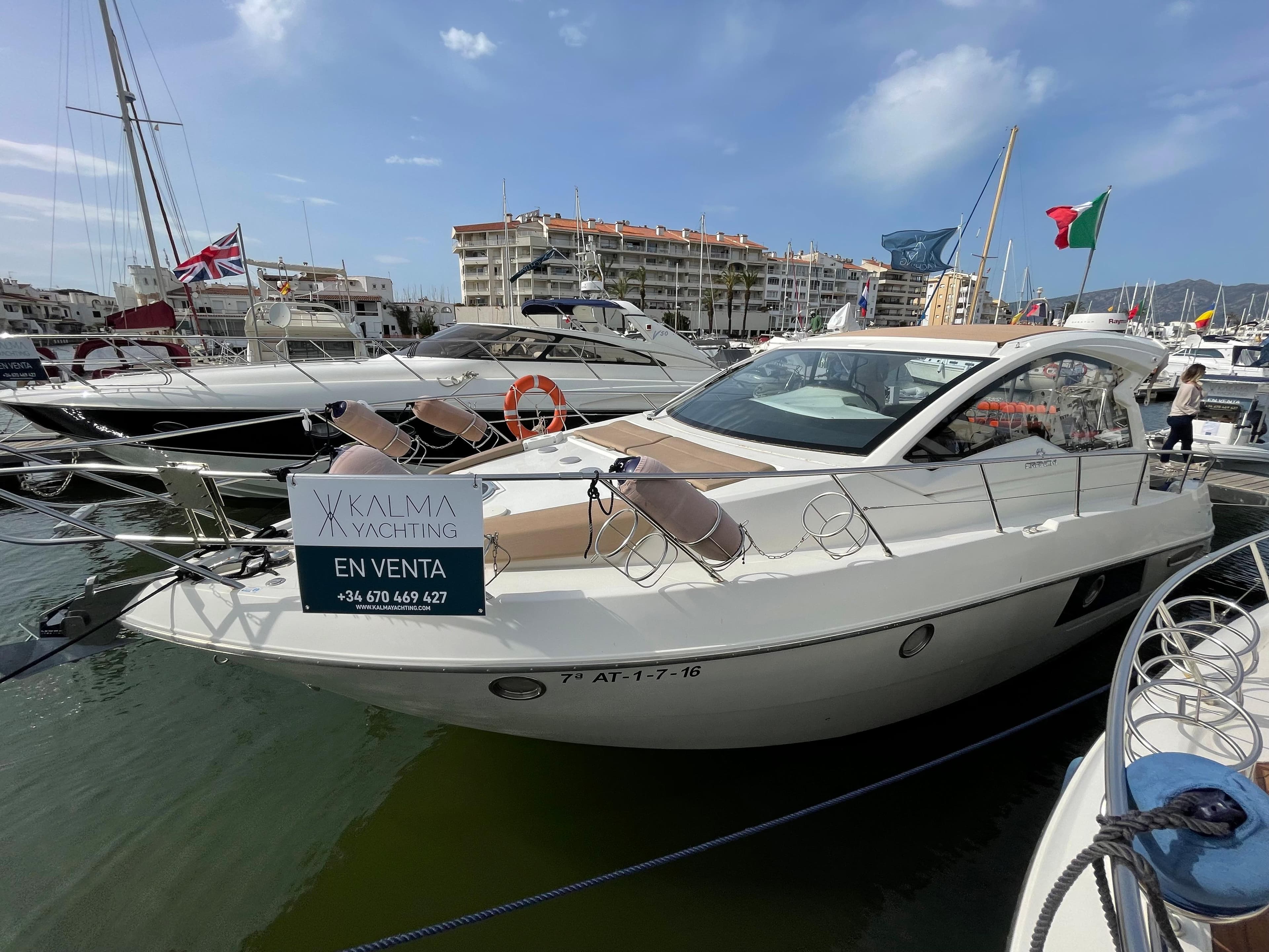 2012 Cranchi M38 yacht for sale, docked in marina, clear sky background.