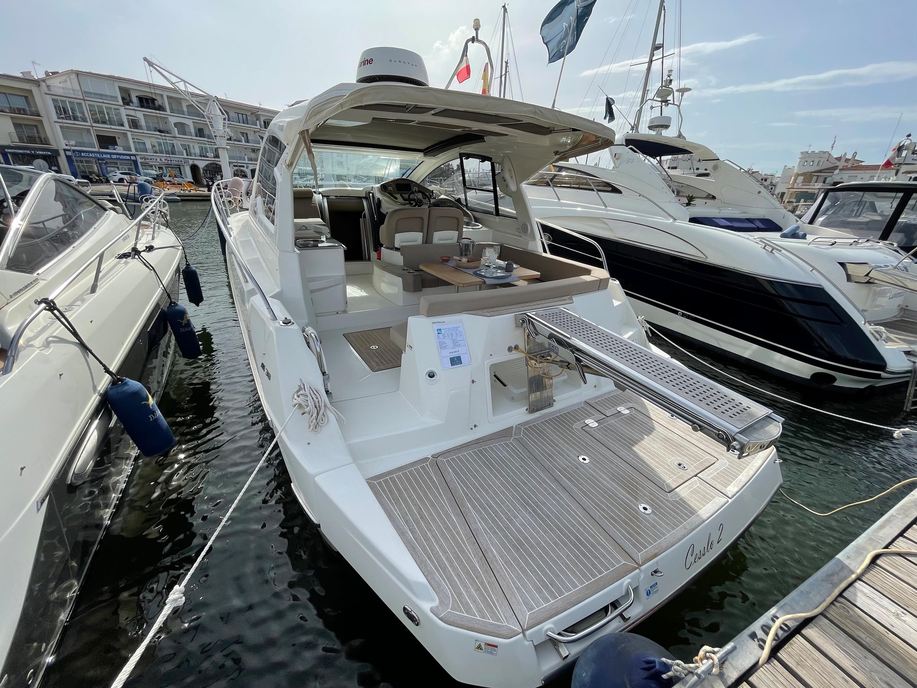 2012 Cranchi M38 yacht docked in marina, featuring spacious deck and modern design.