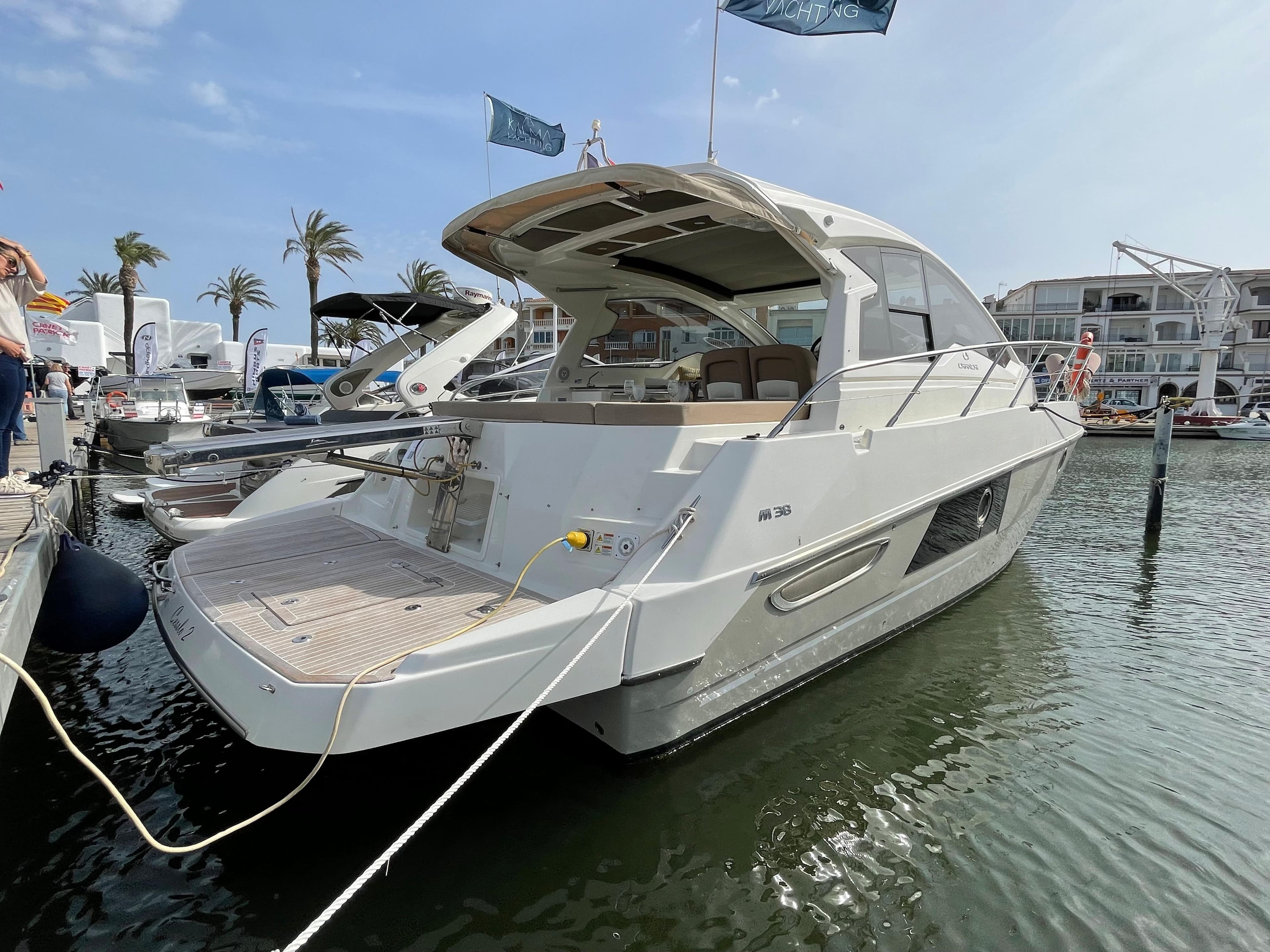 2012 Cranchi M38 yacht docked at marina, featuring sleek design and spacious deck.