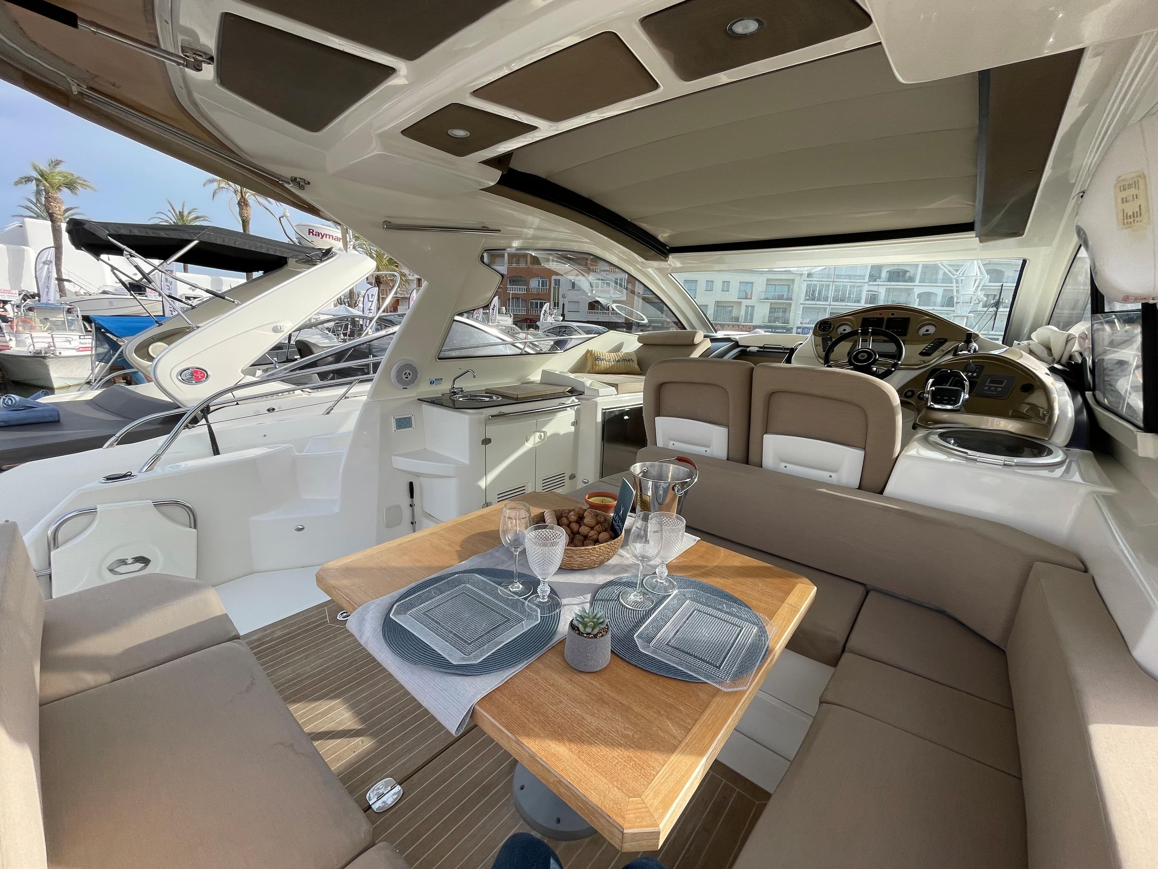 Luxurious interior of 2012 Cranchi M38 yacht with elegant dining setup and modern helm.
