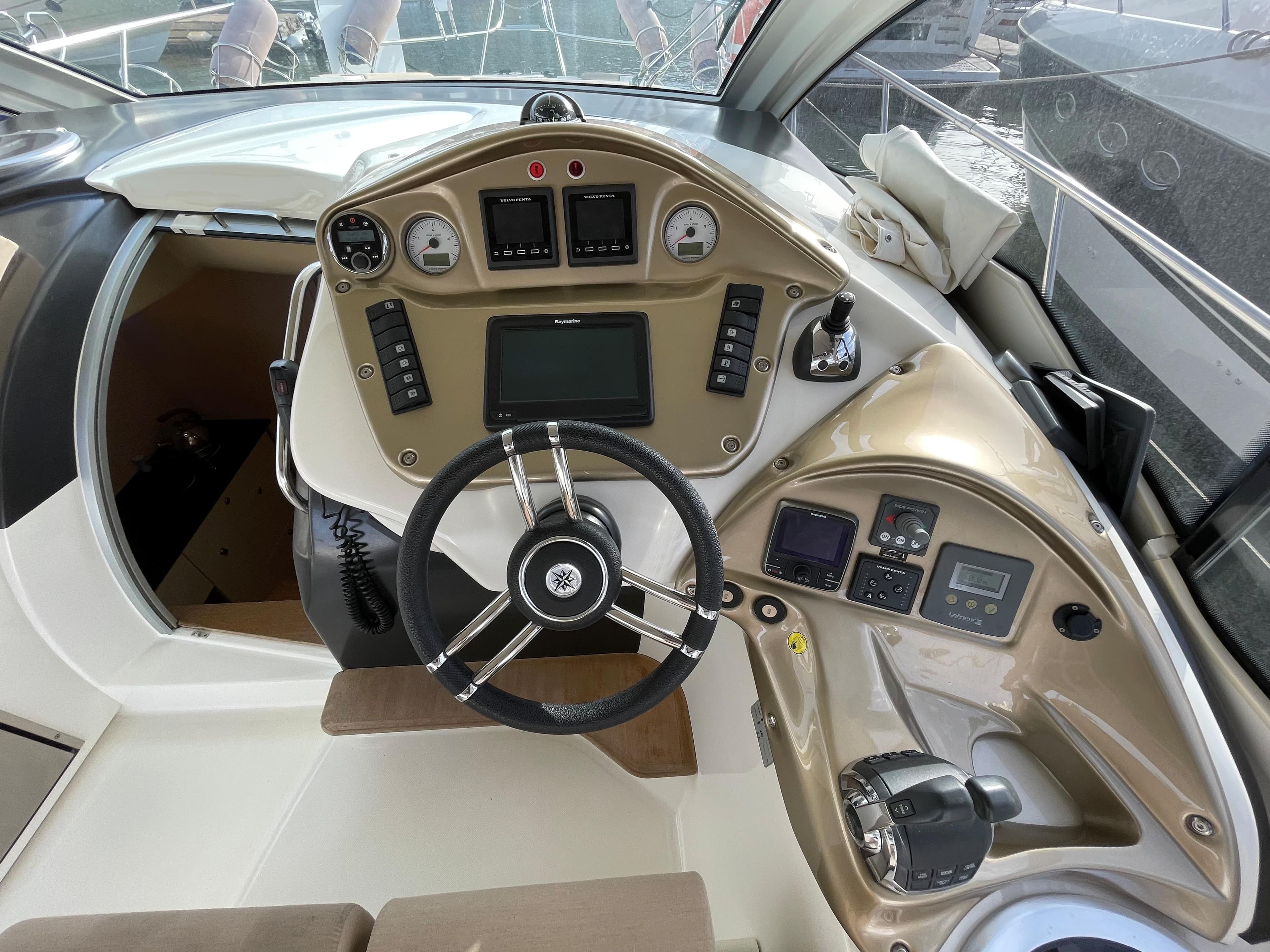Cockpit of 2012 Cranchi M38 yacht with steering wheel and control panel.