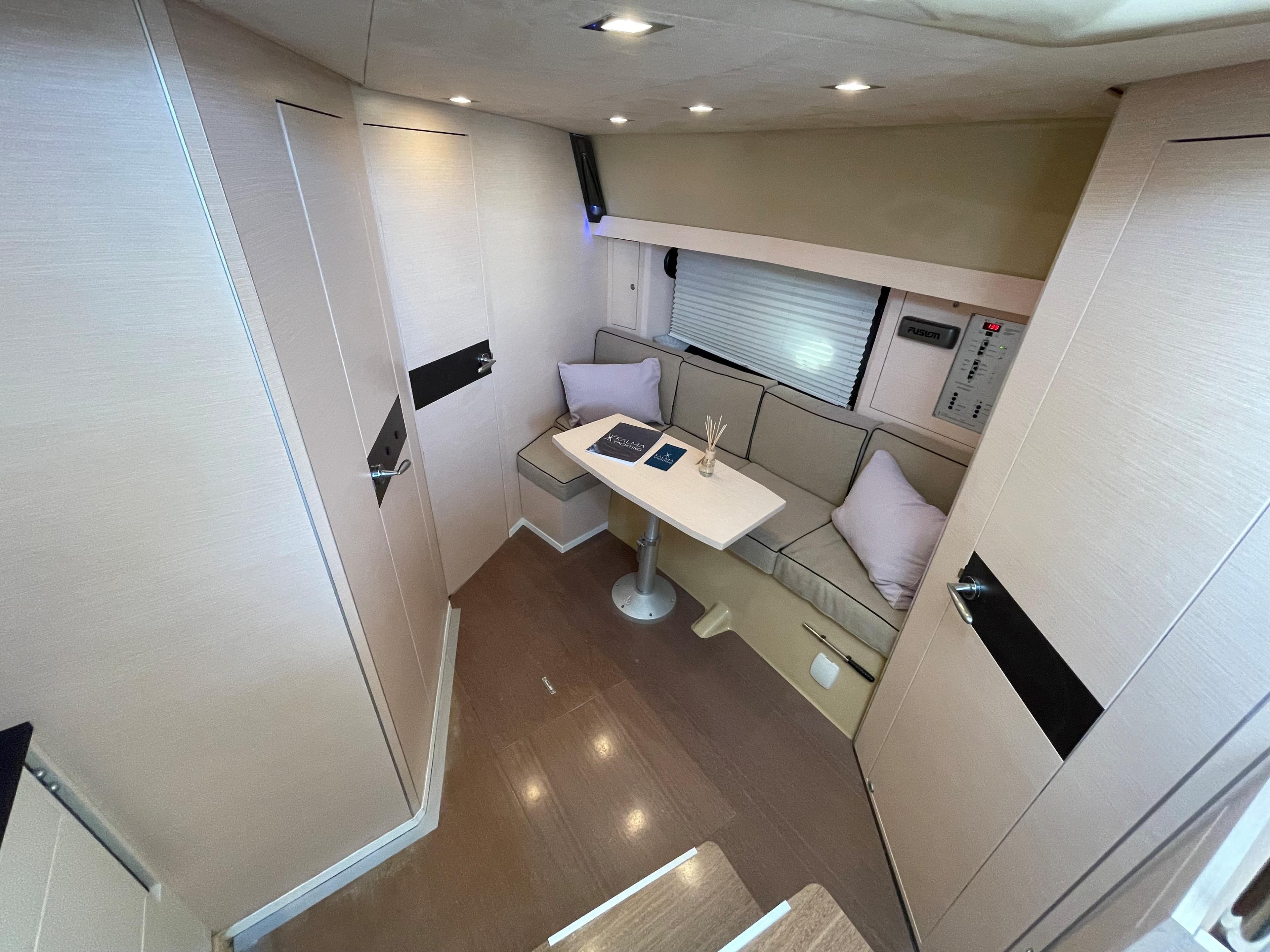 Interior of 2012 Cranchi M38 yacht with modern seating and table setup.