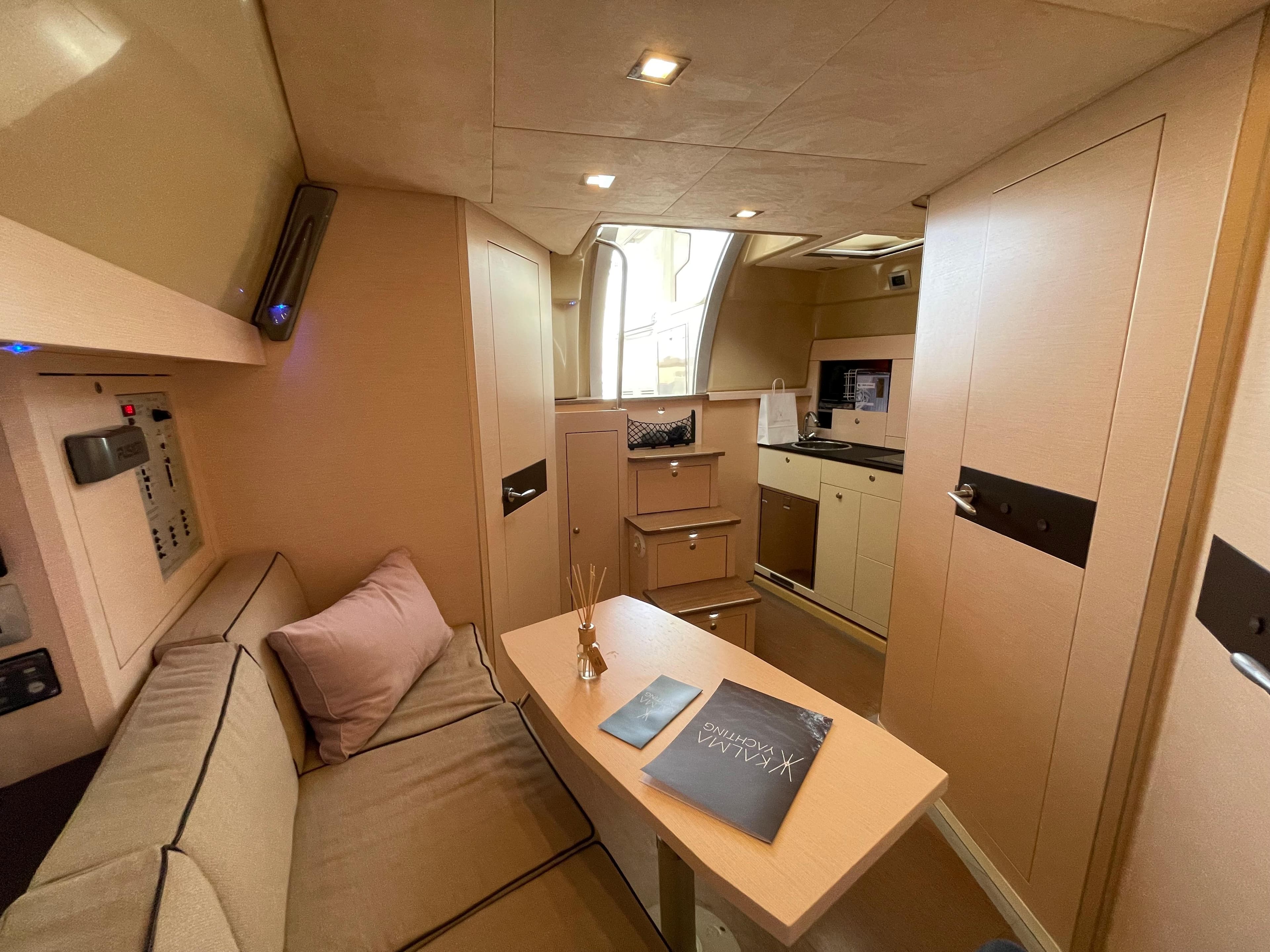Interior of 2012 Cranchi M38 yacht, featuring cozy seating and modern kitchen area.