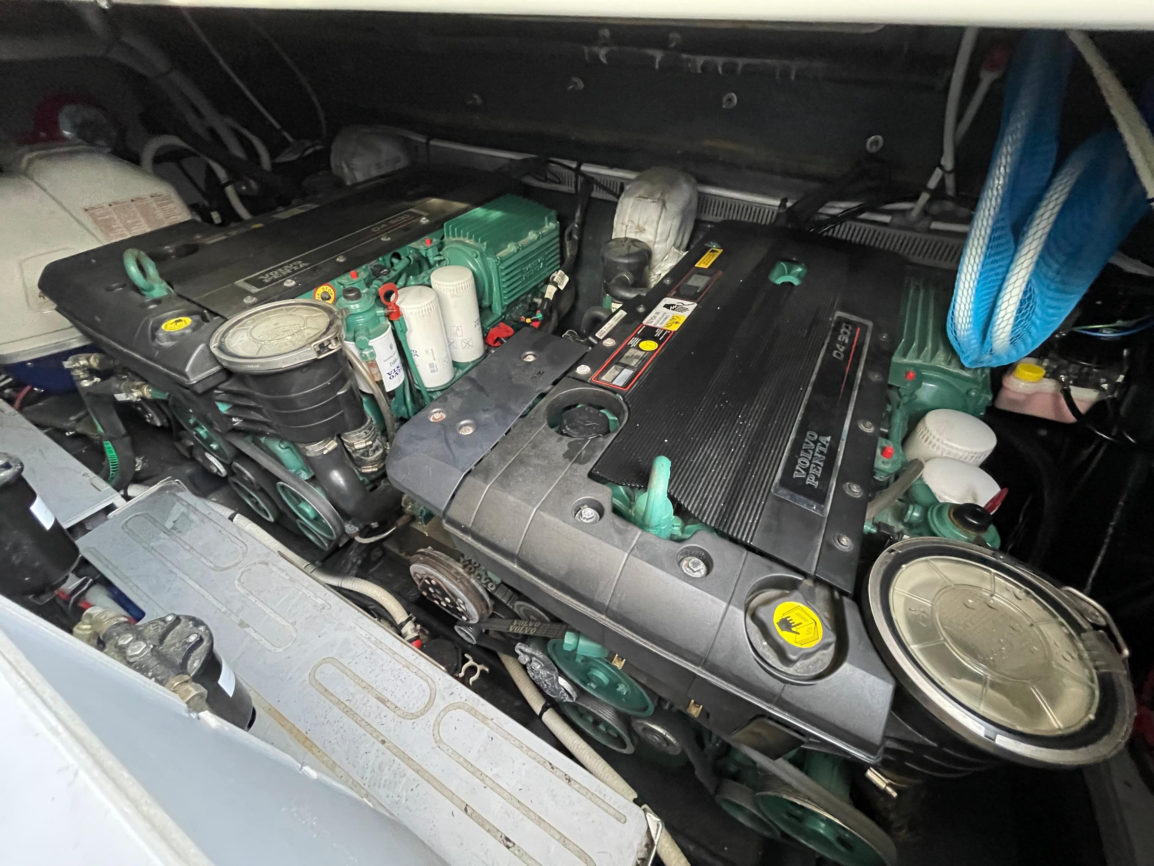 Engine compartment of a 2012 Cranchi M38 boat, showcasing dual engines and mechanical components.