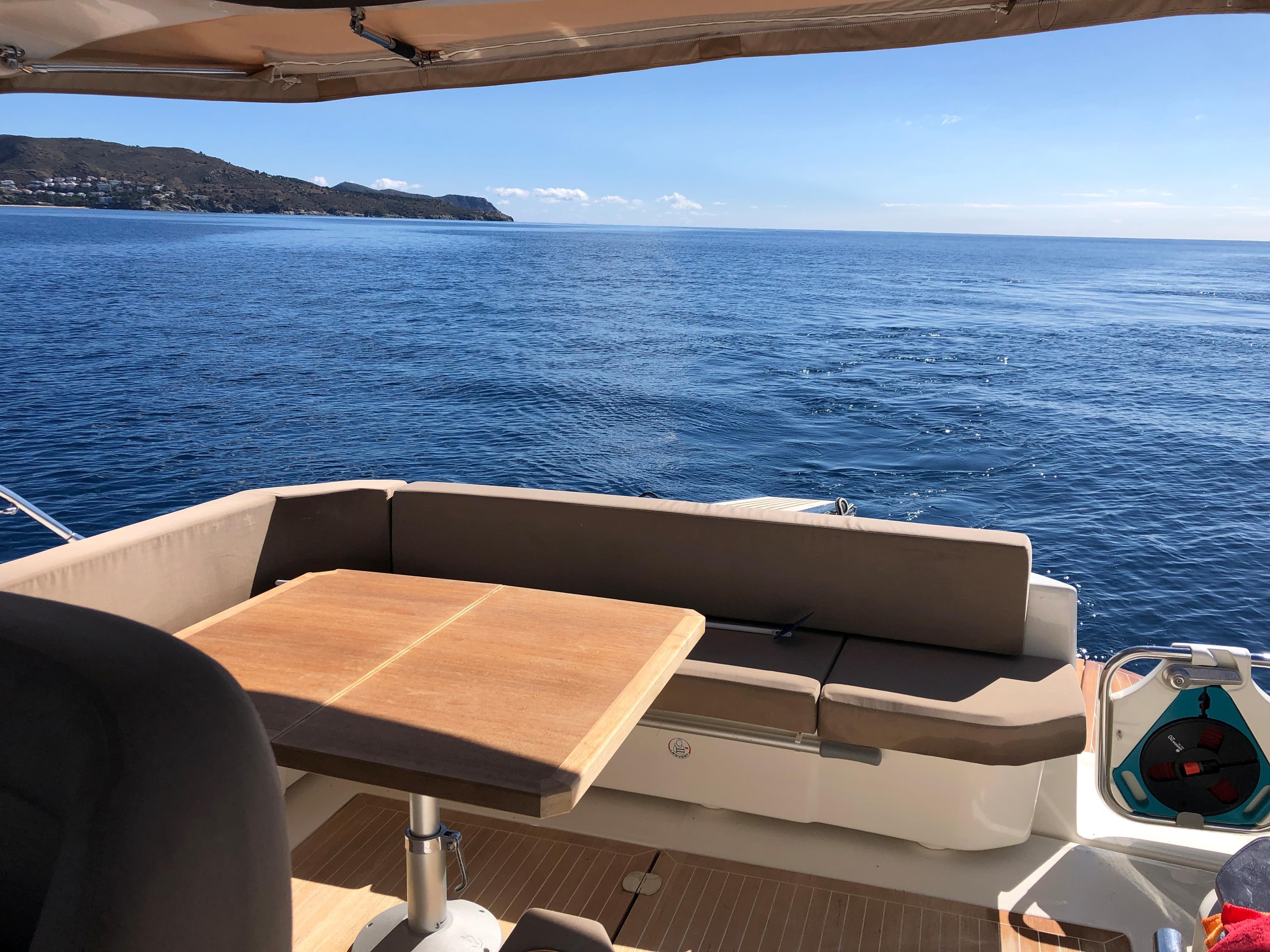 Cranchi M38 yacht deck with seating, ocean view, and distant coastline, 2012 model.