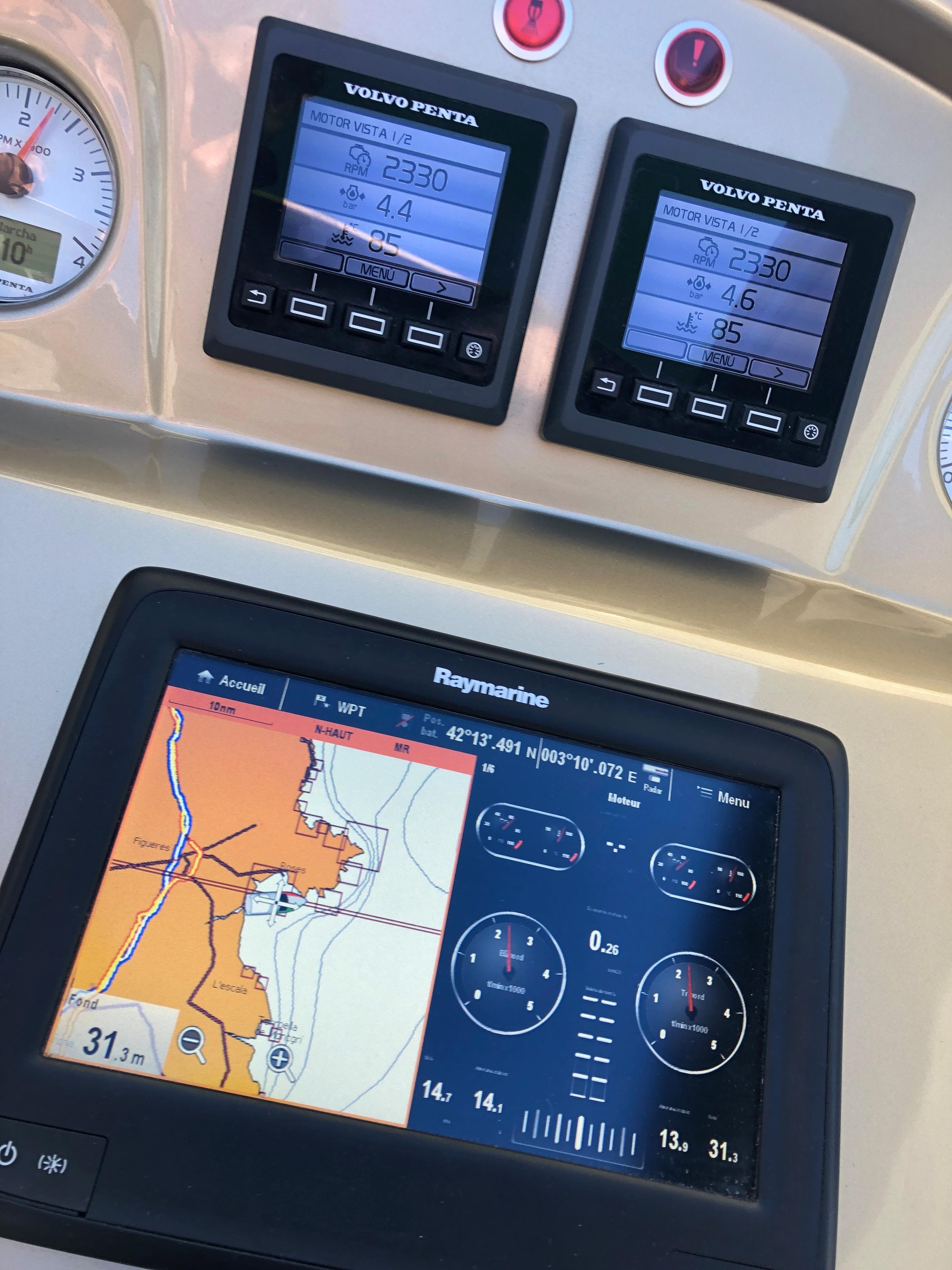Cranchi M38 2012 dashboard with Volvo Penta displays and Raymarine navigation system.