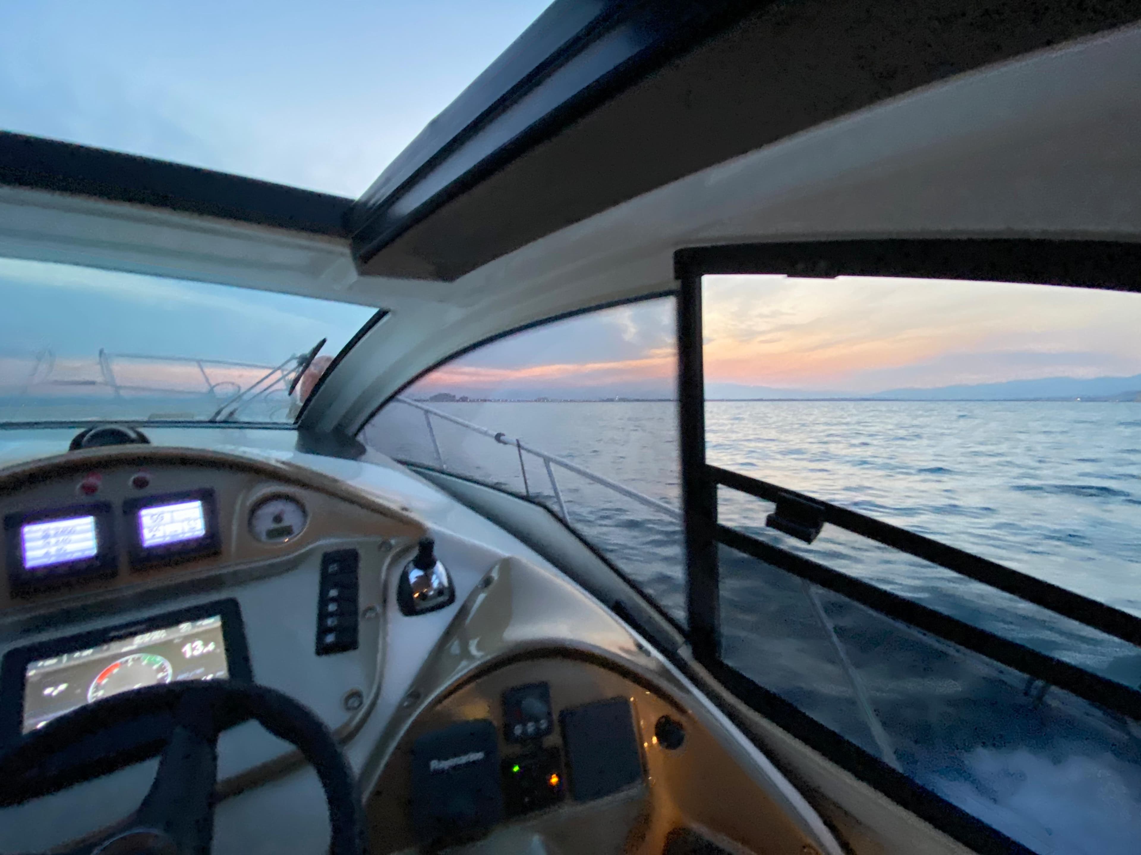 Cranchi M38 yacht interior view at sunset, 2012 model, overlooking serene ocean waters.