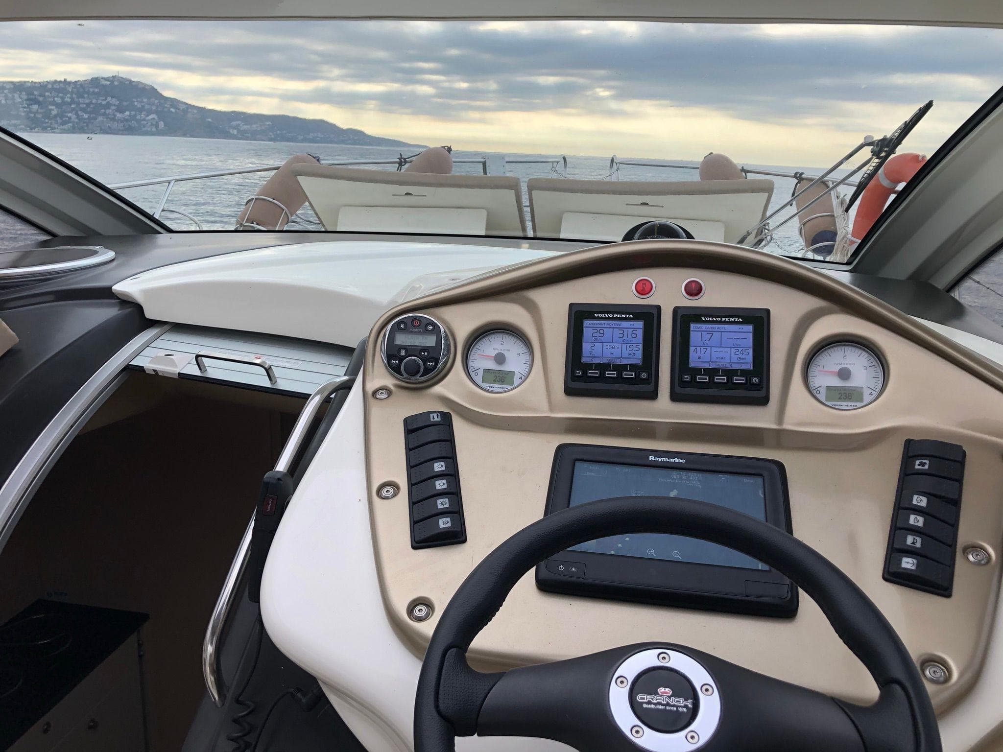 Cockpit view of 2012 Cranchi M38 yacht with dashboard and steering wheel.