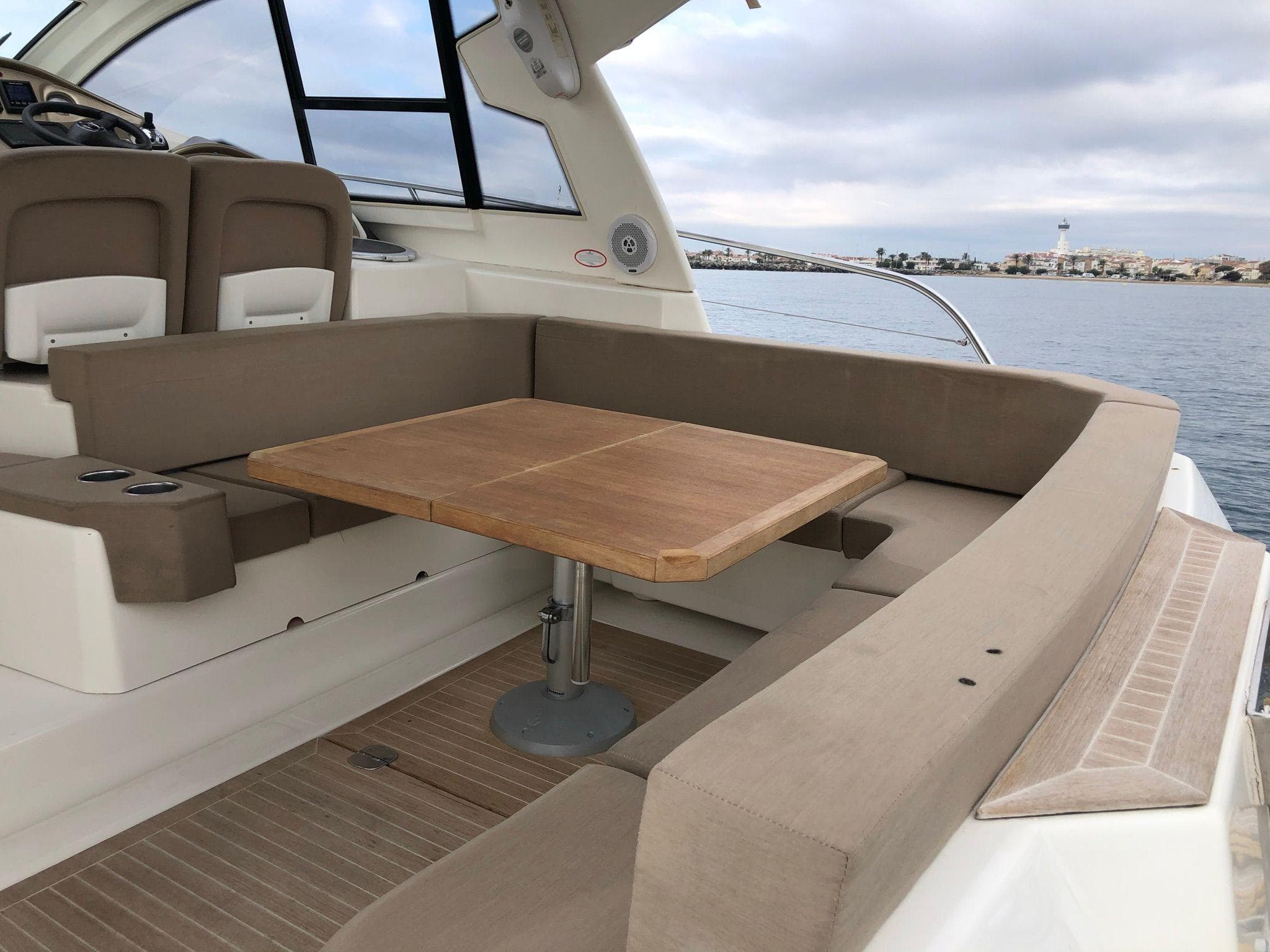 Cranchi M38 yacht interior with beige seating and wooden table, 2012 model.