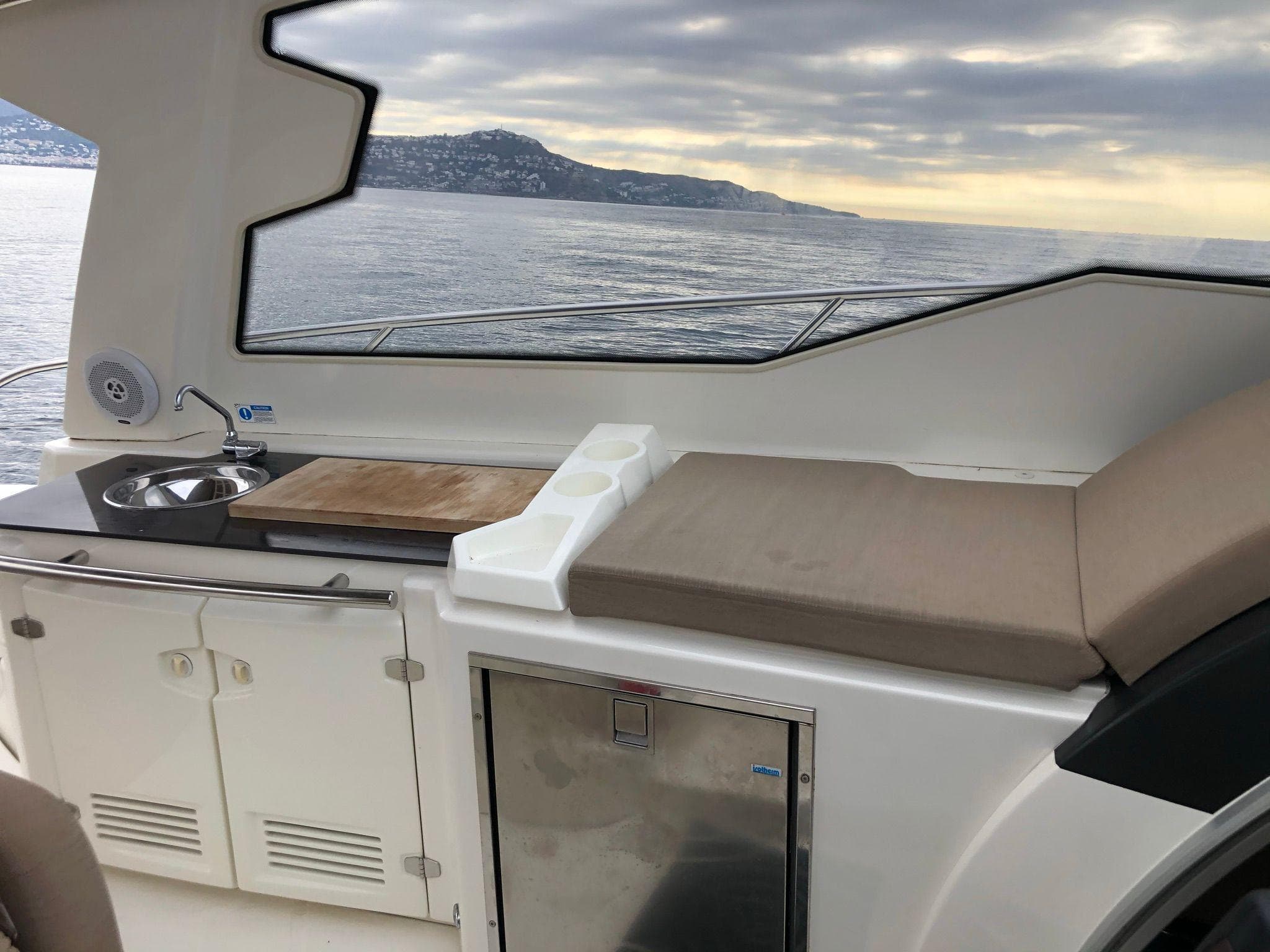 Interior of 2012 Cranchi M38 yacht with kitchenette and sea view.