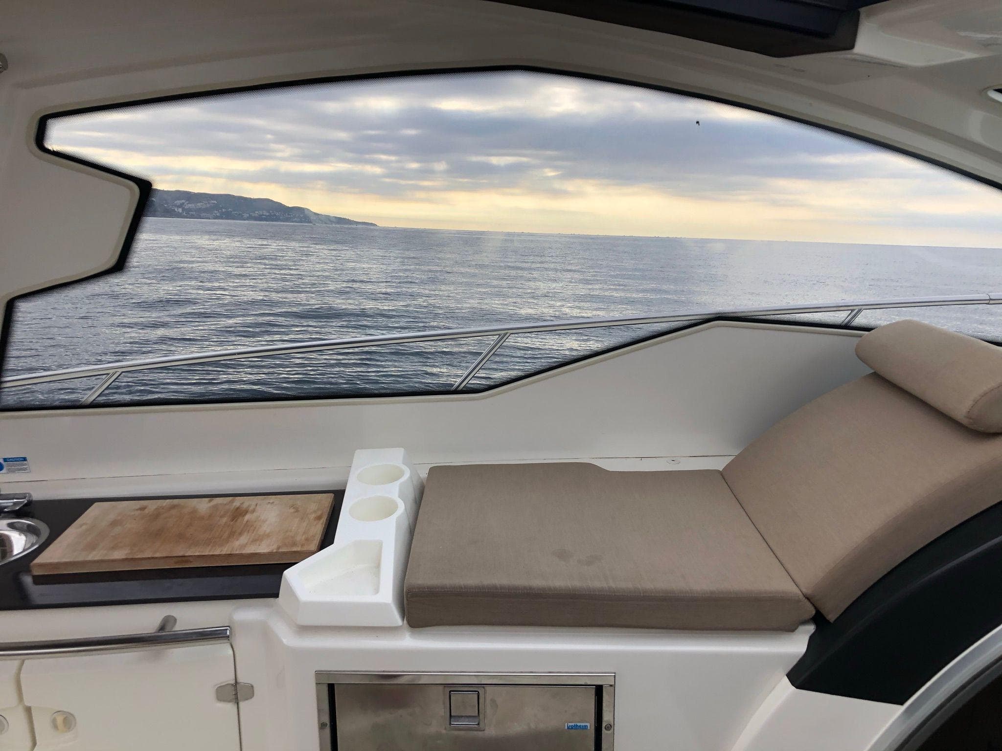 Luxurious 2012 Cranchi M38 yacht interior with ocean view and comfortable seating.