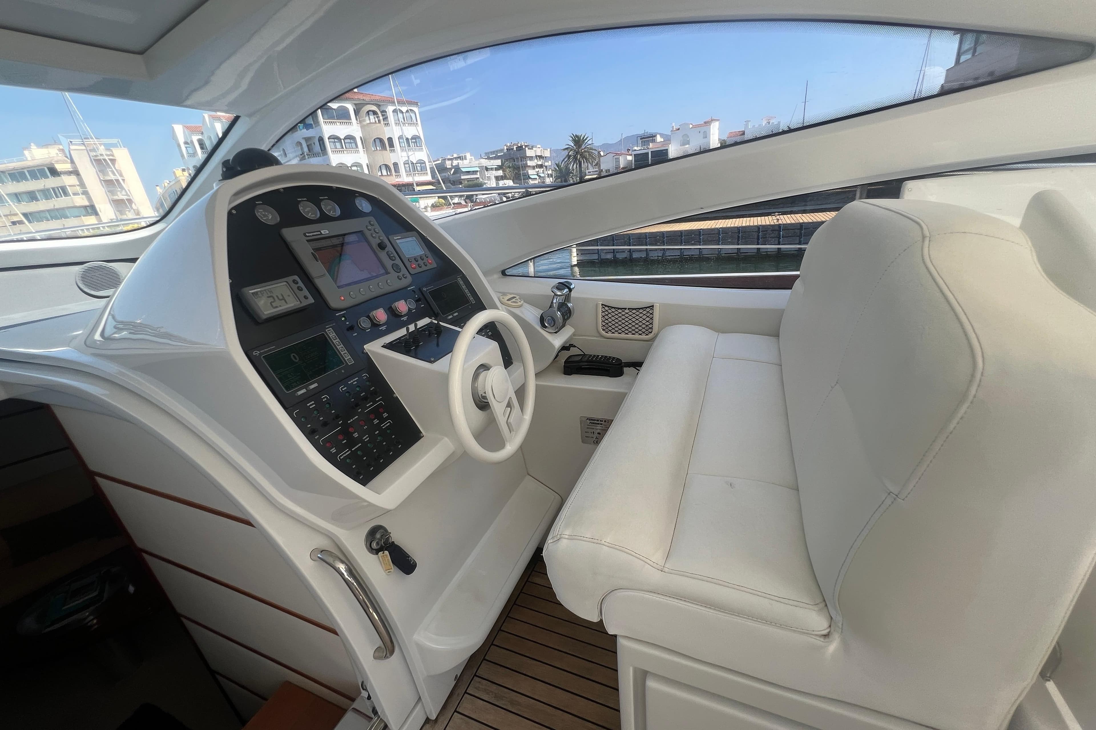 Helm of 2007 Pershing 50 yacht with modern navigation controls and white seating.