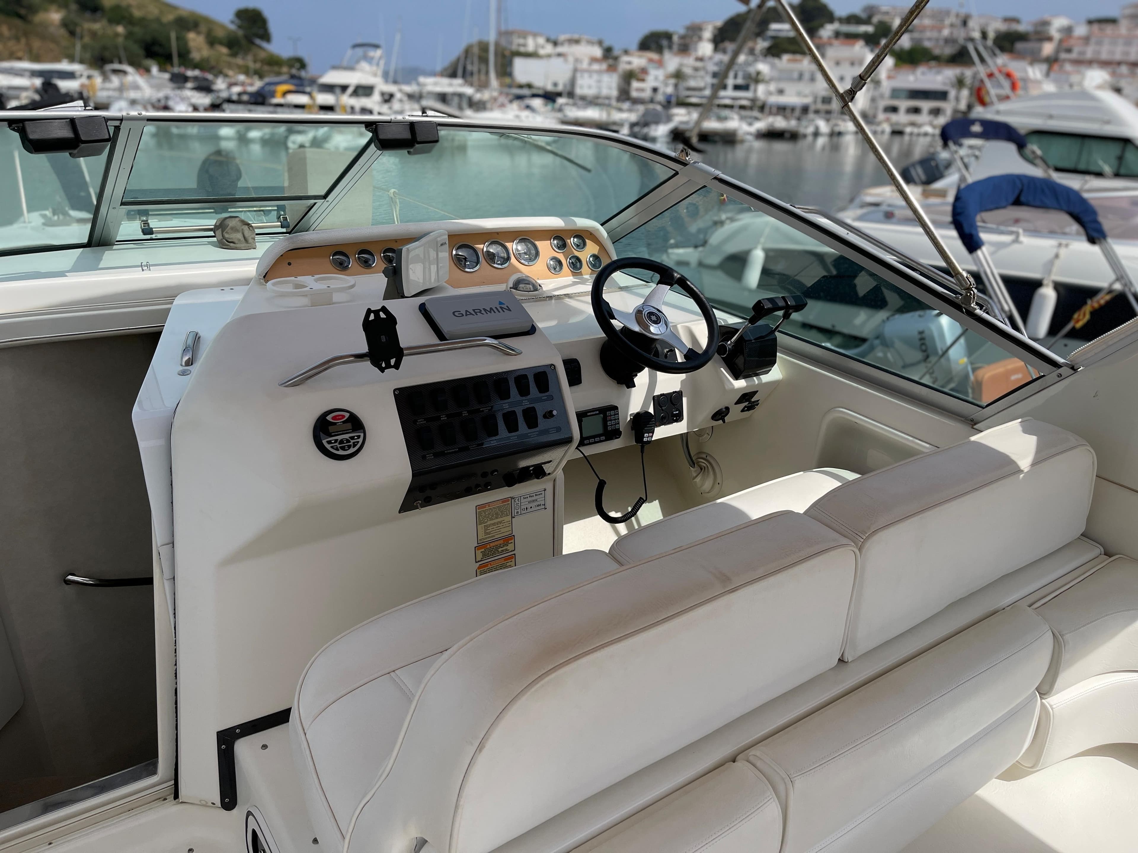 The image shows the cockpit of a 1997 Sea Ray 290 Sundancer with a sleek helm station.