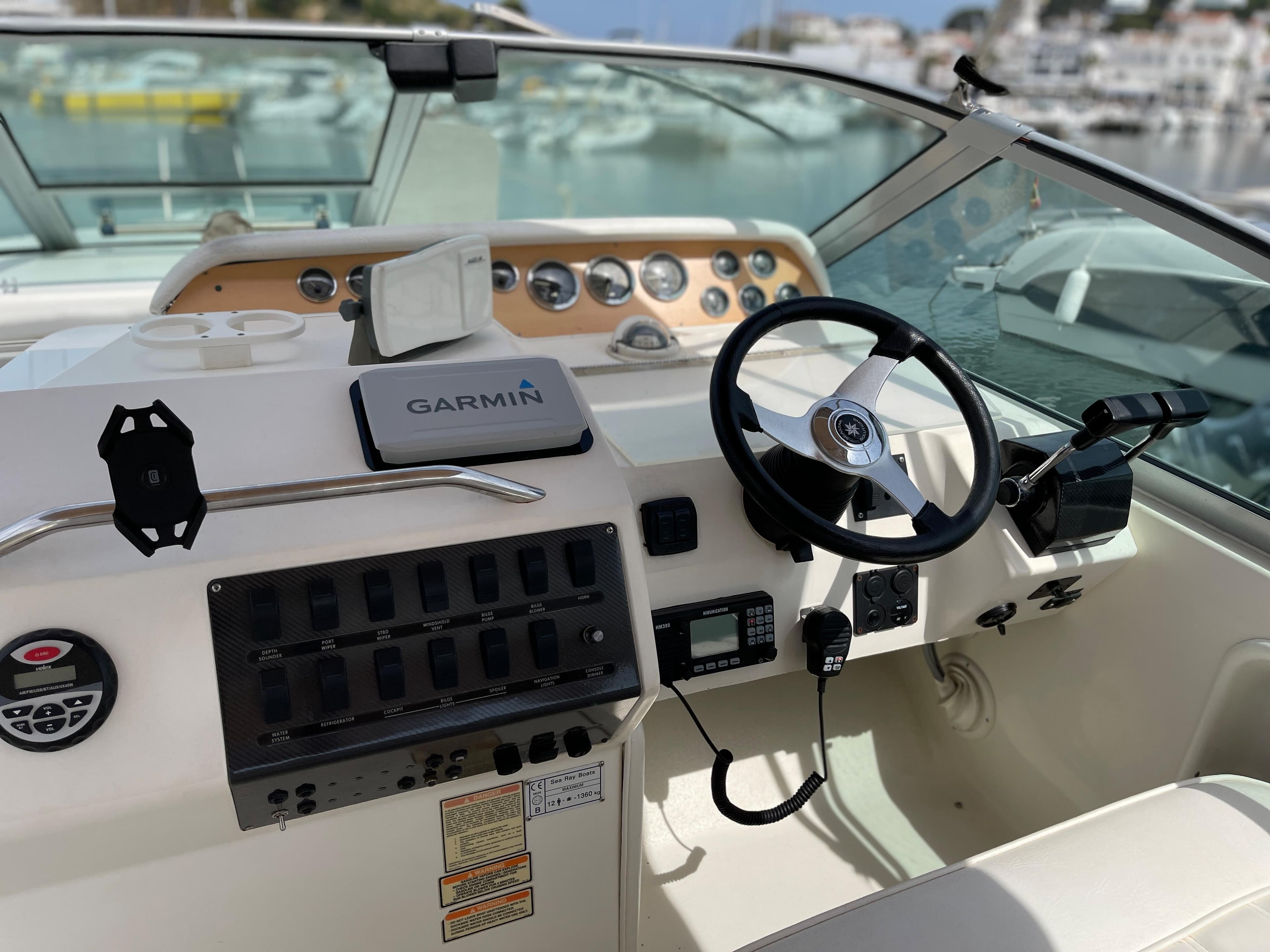 The image shows the cockpit of a 1997 Sea Ray 290 Sundancer with a Garmin navigation system.