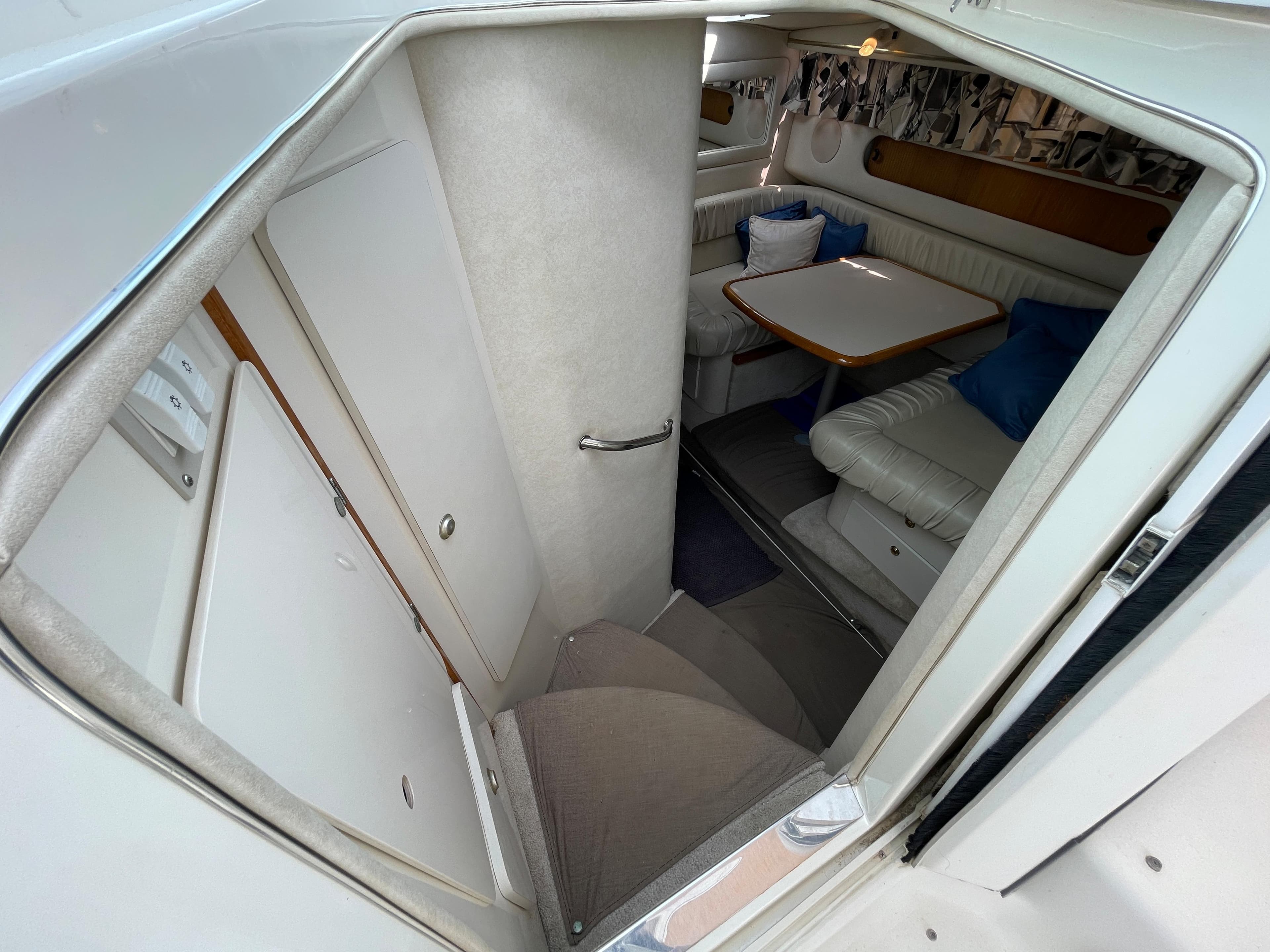 Interior of a 1997 Sea Ray 290 Sundancer with seating area and table.