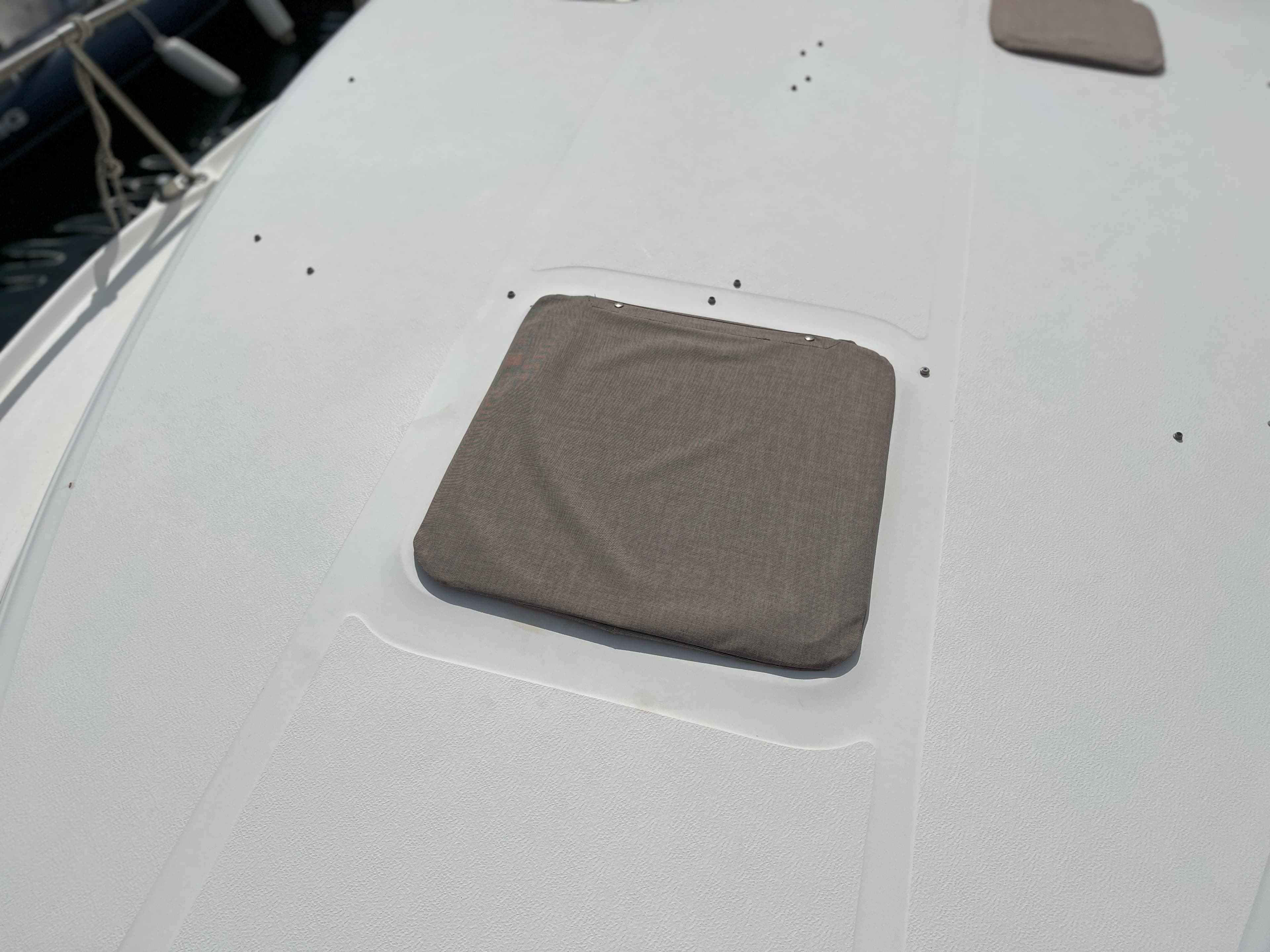 The image shows the deck of a 1997 Sea Ray 290 Sundancer with a square hatch cover.