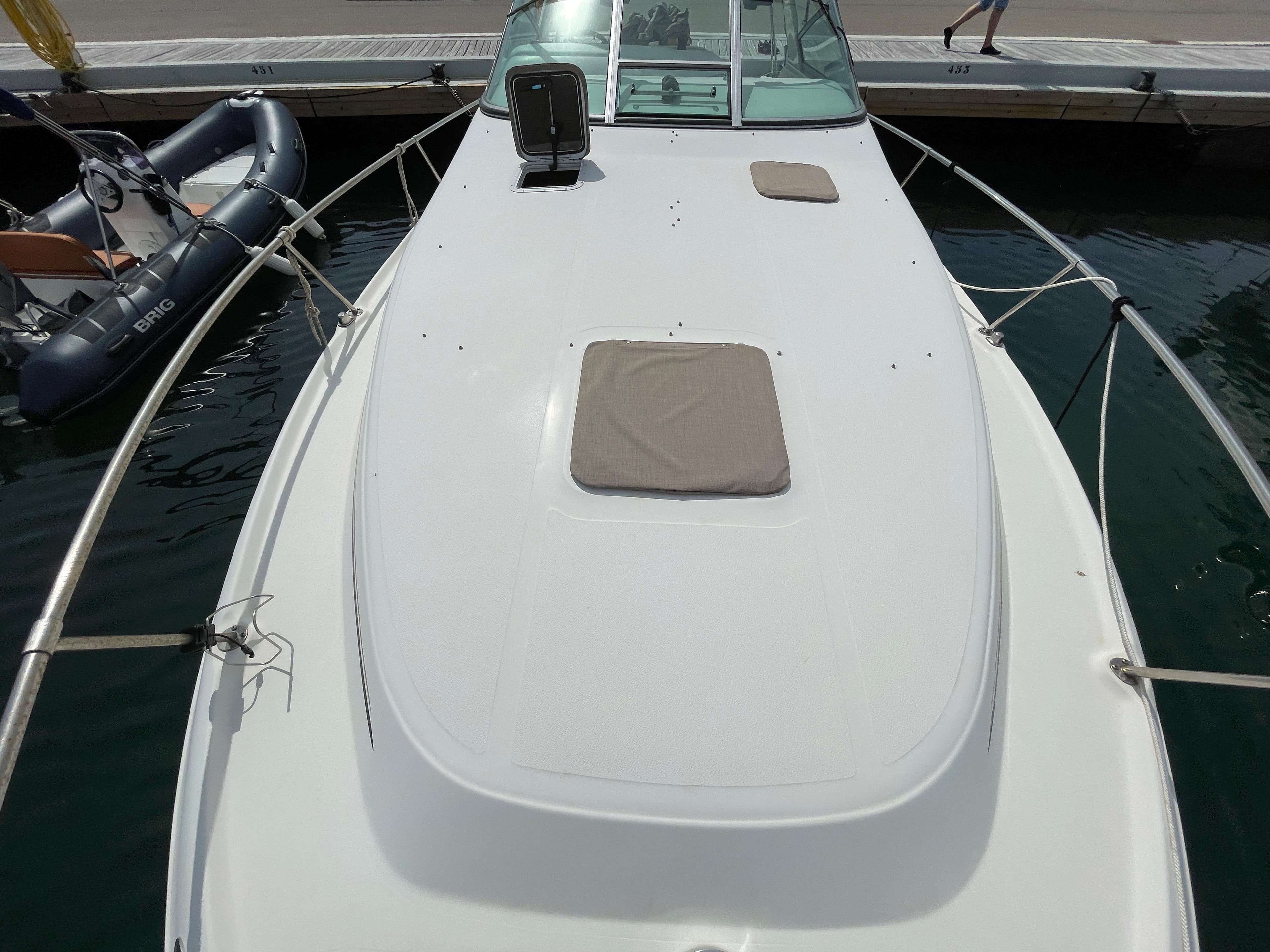 The image shows the deck of a 1997 Sea Ray 290 Sundancer docked at a pier.