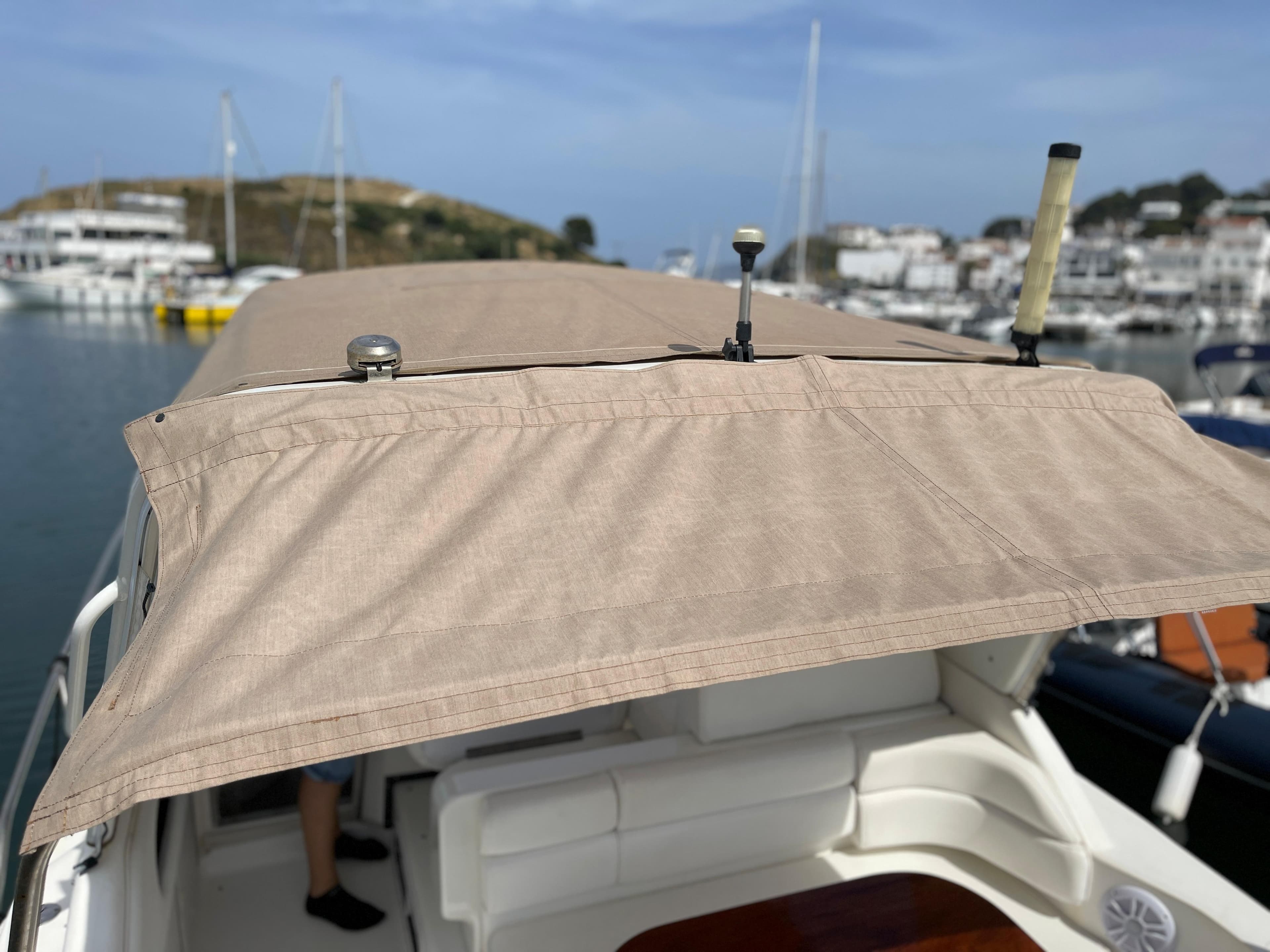The image shows the canopy of a 1997 Sea Ray 290 Sundancer in a harbor.