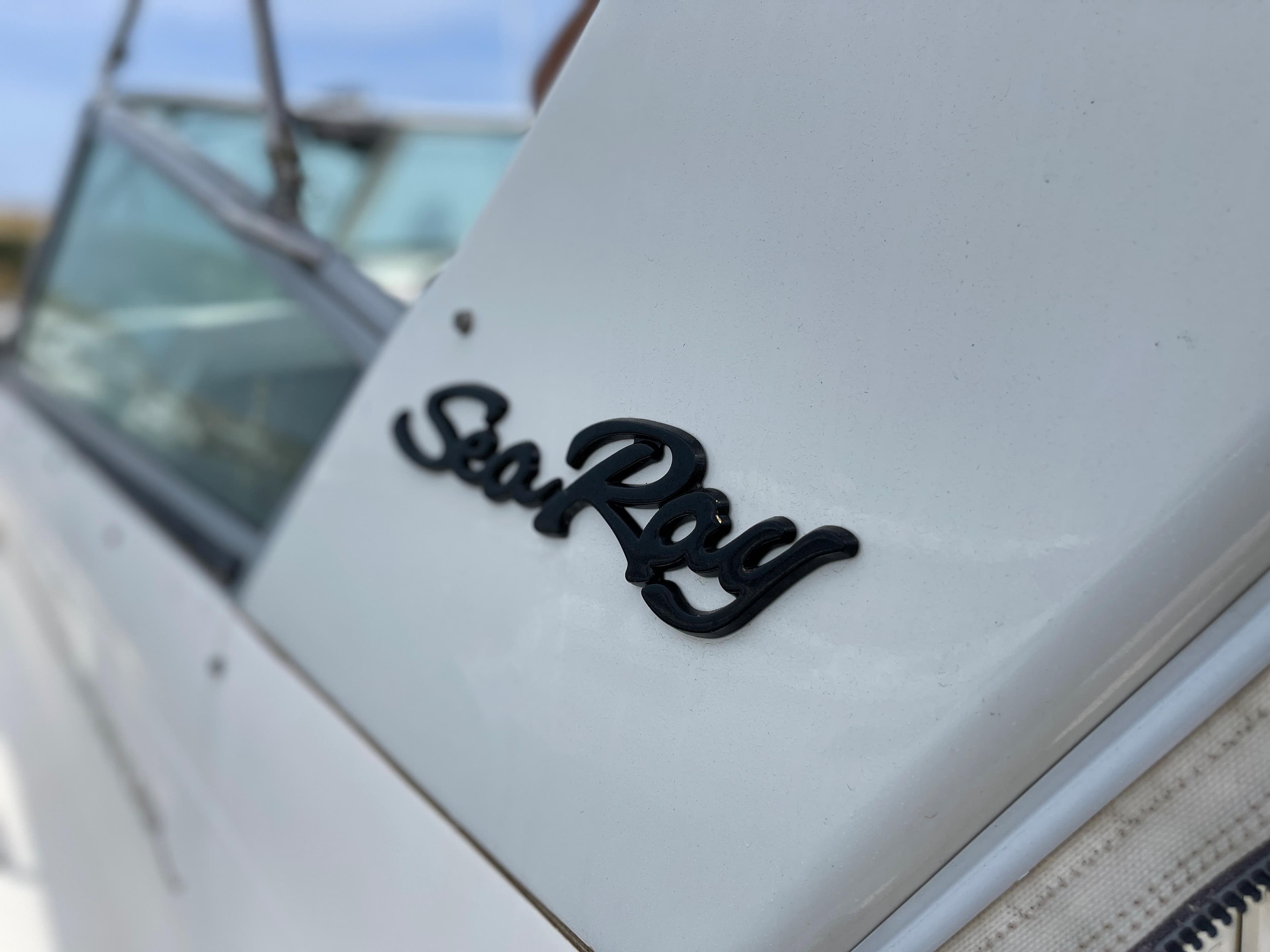 Close-up of the Sea Ray logo on a white boat.