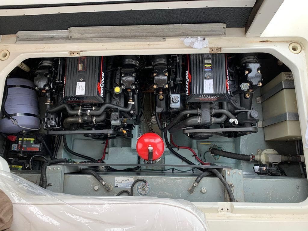 The engine compartment of a 1997 Sea Ray 290 Sundancer showing two engines and various components.