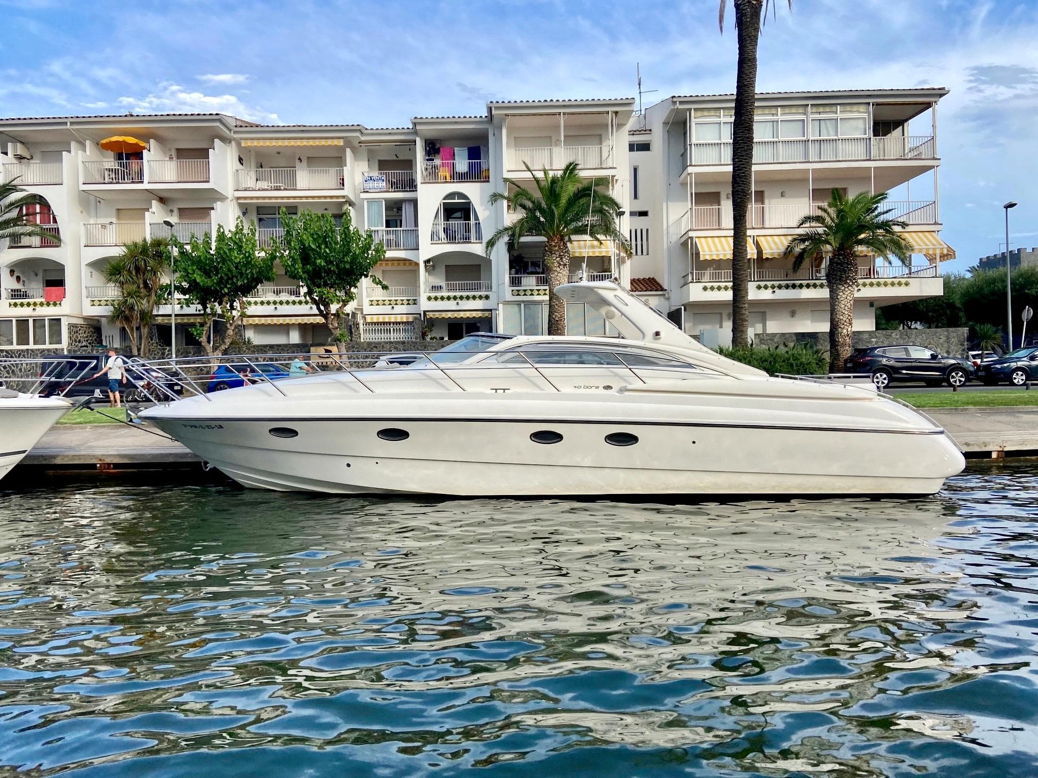 2003 Windy Bora 40 yacht docked near modern apartments.