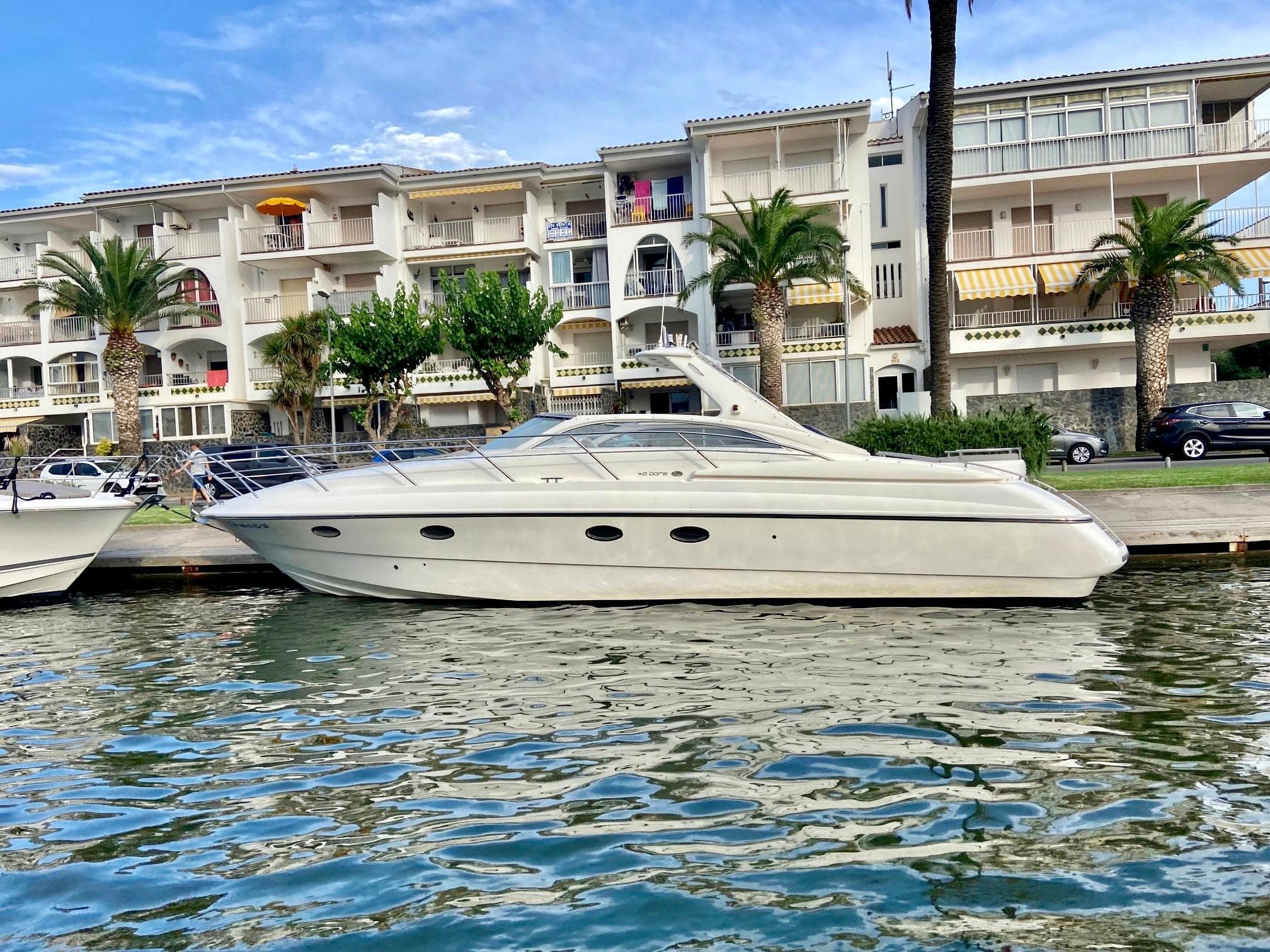 2003 Windy Bora 40 yacht docked by waterfront buildings.
