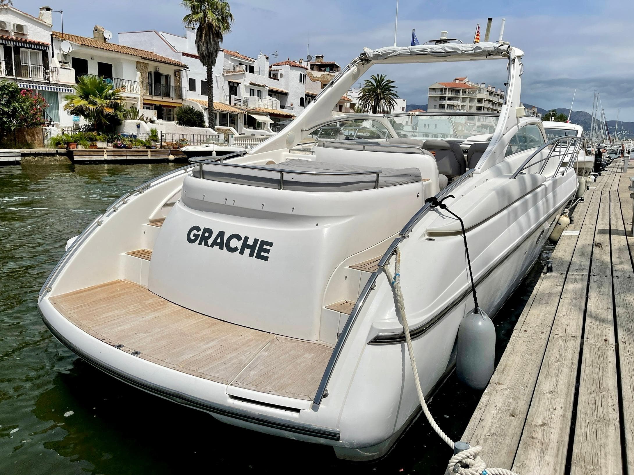 2003 Windy Bora 40 yacht docked by waterfront homes.