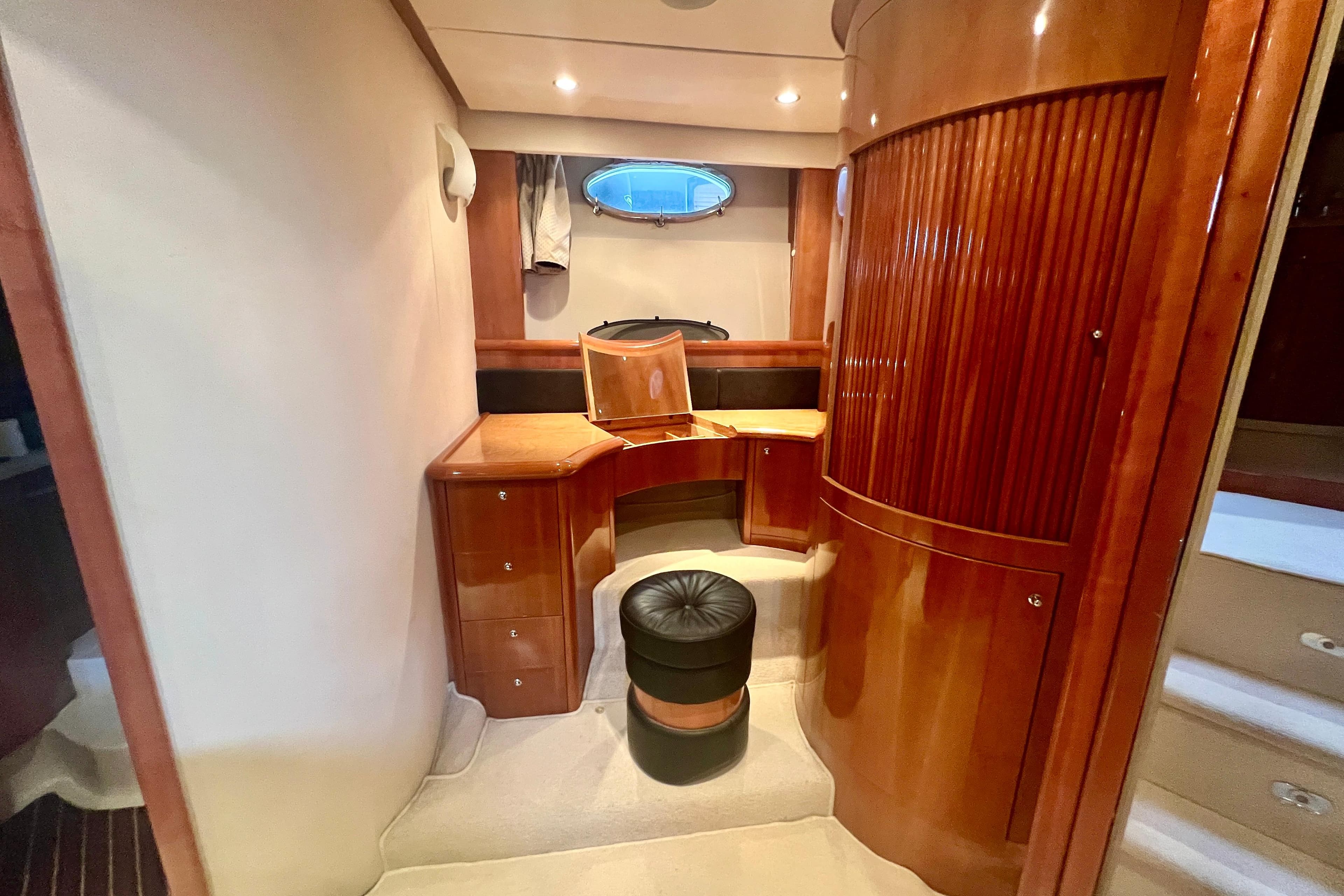 Luxurious wooden interior of a 2002 Aicon 56 yacht with elegant cabinetry and seating.