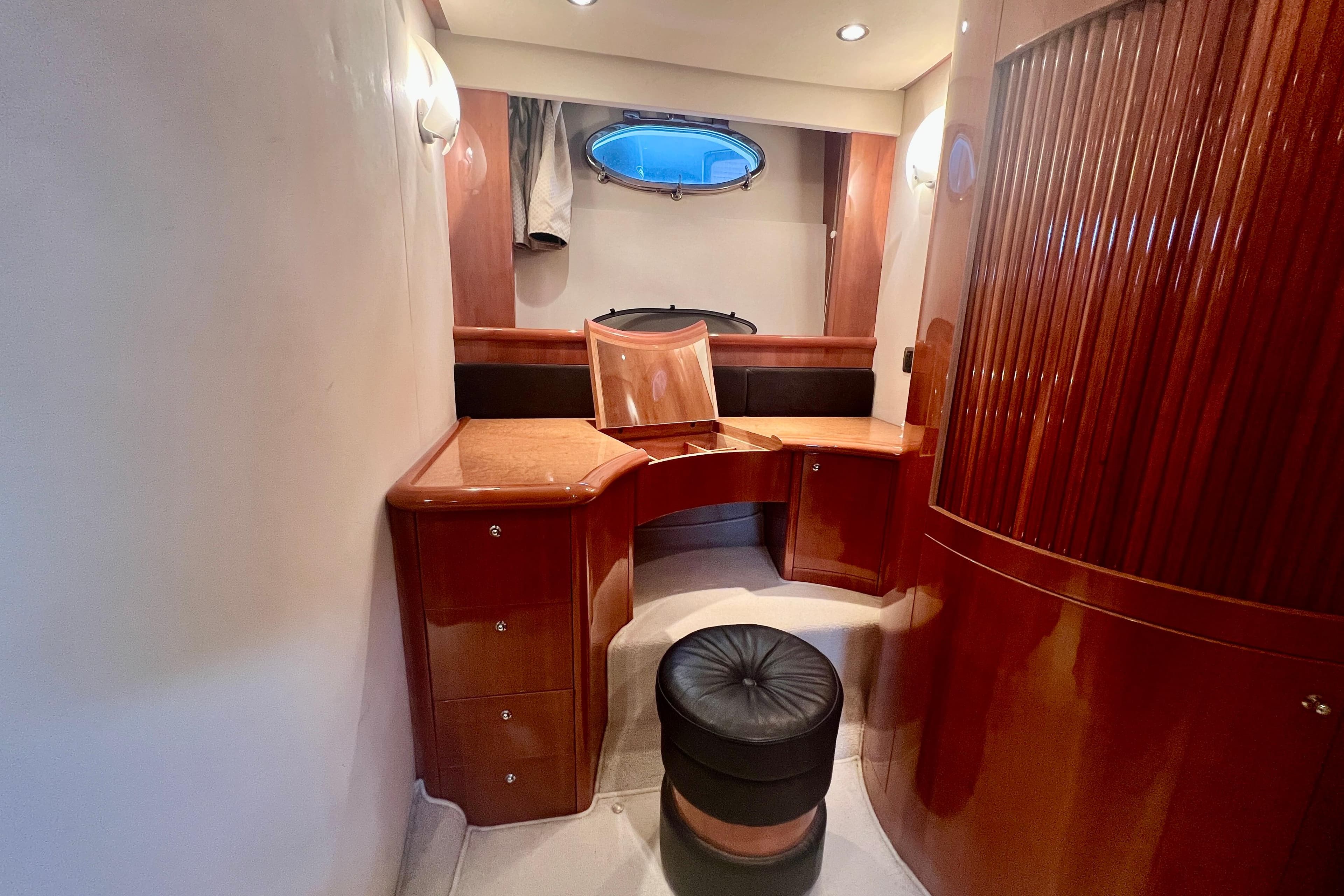 Luxurious wooden interior of 2002 Aicon 56 yacht with seating and storage.