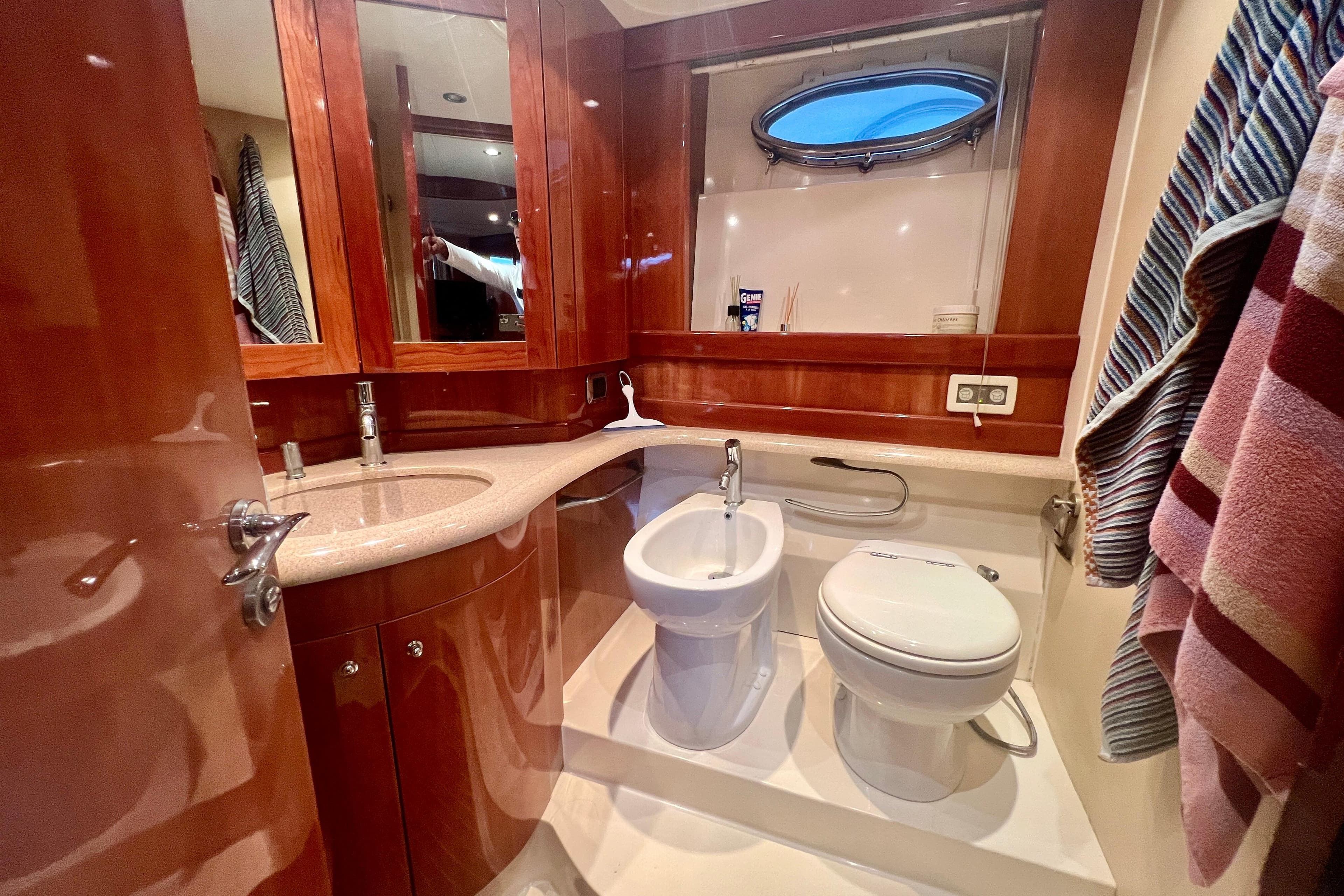 Luxurious bathroom in 2002 Aicon 56 yacht with wood accents and modern fixtures.