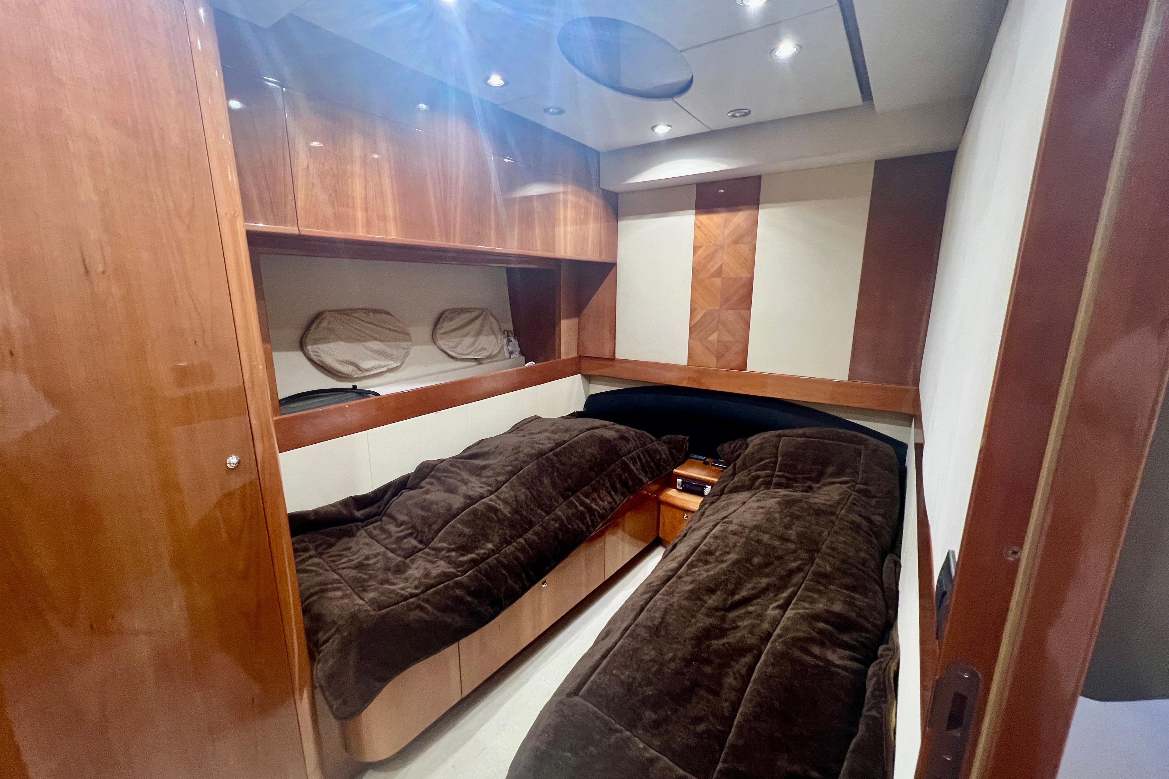 Luxurious cabin interior of 2002 Aicon 56 yacht with twin beds and wood paneling.