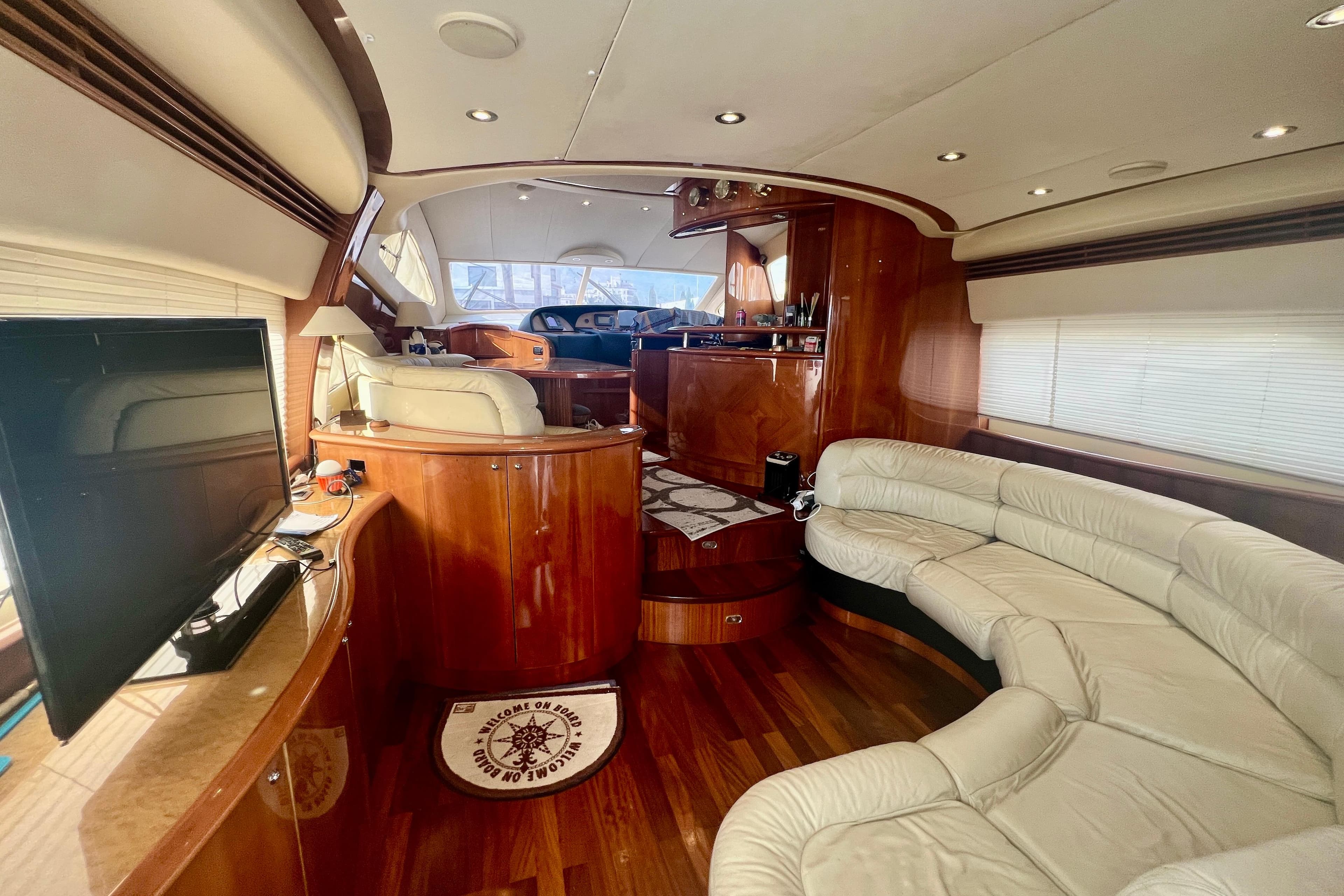 Luxurious interior of 2002 Aicon 56 yacht with leather seating and wooden finishes.
