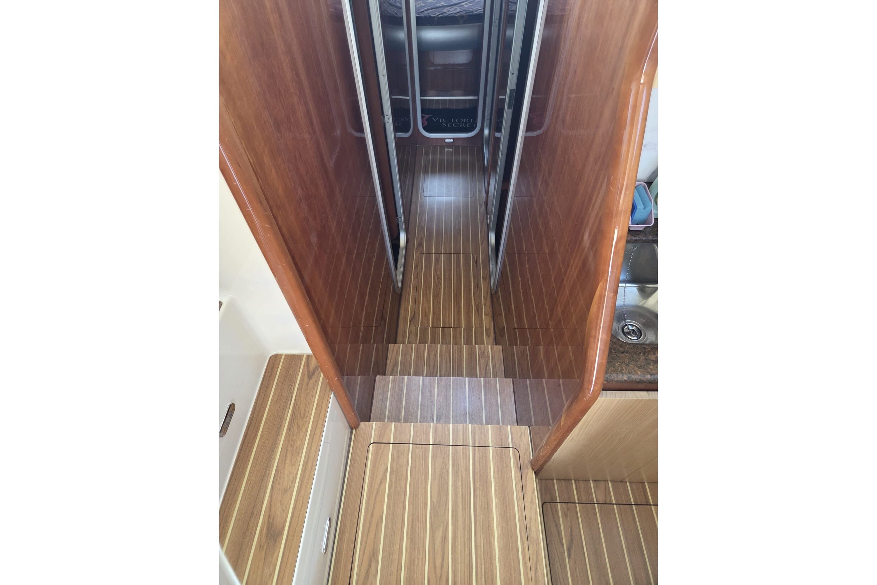 Interior view of 1994 Azimut 43 yacht with wooden flooring and narrow passageway.