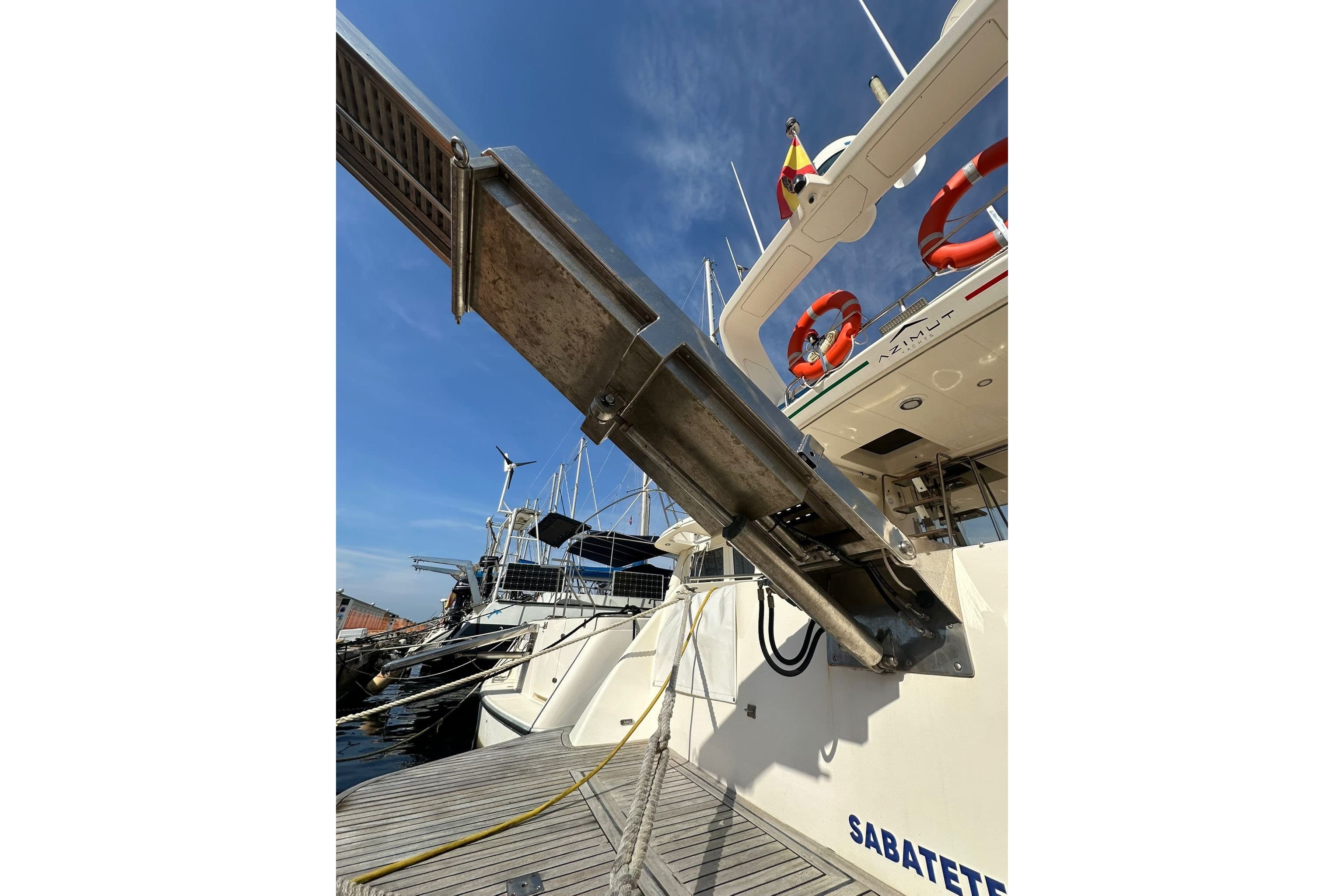 Azimut 43 yacht from 1994 docked, featuring a gangway and life rings.