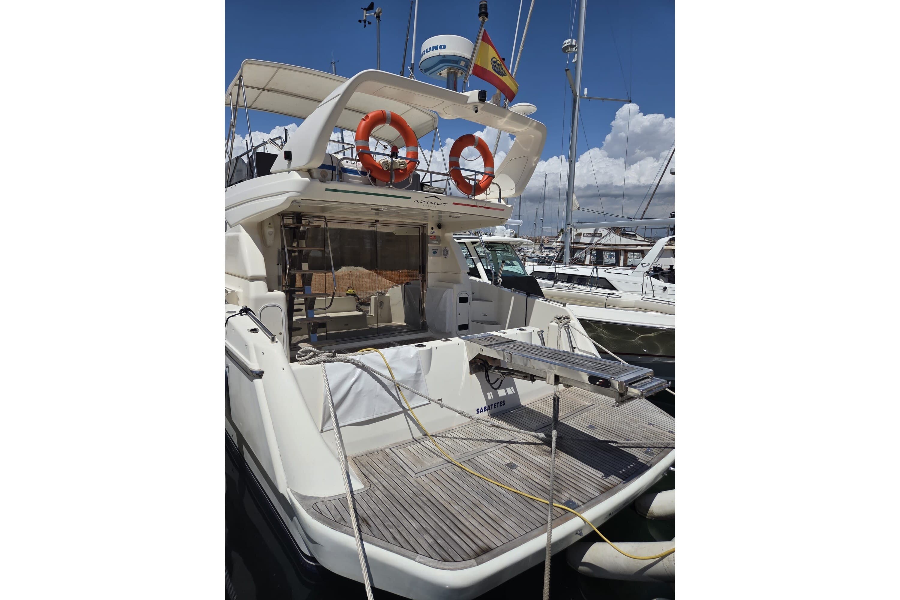 1994 Azimut 43 yacht docked, featuring a spacious deck and safety equipment.
