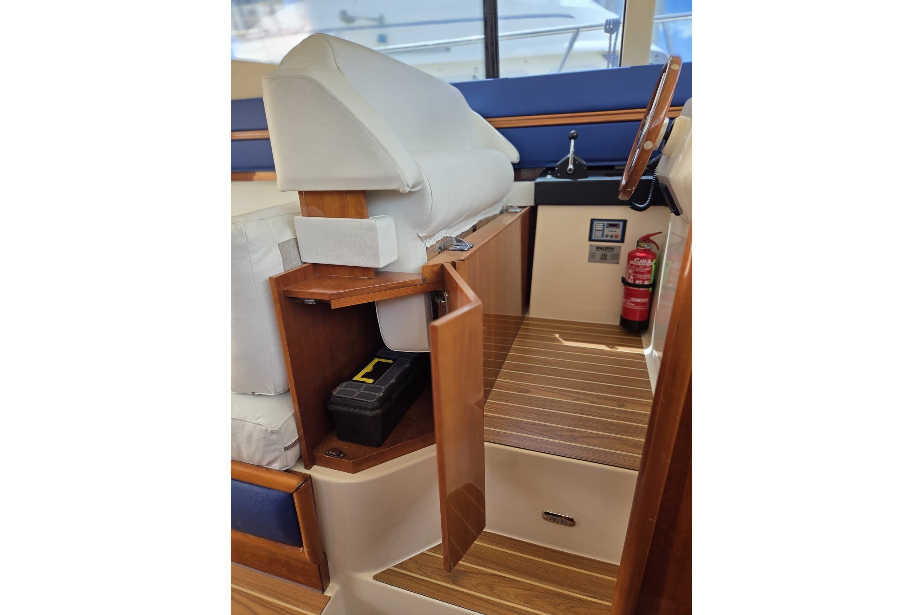 Interior of 1994 Azimut 43 yacht helm with wooden flooring and storage compartment.