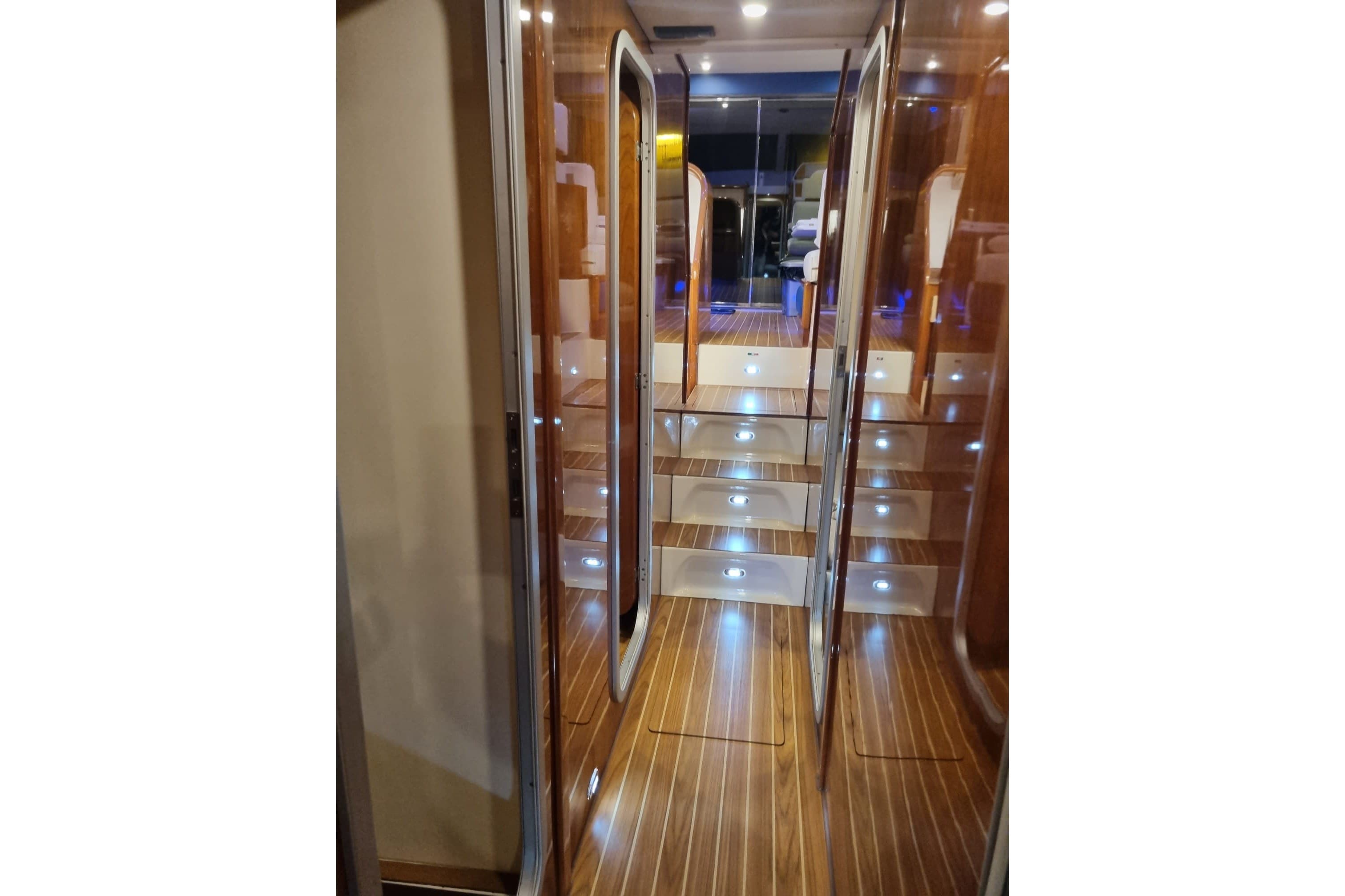 Luxurious interior hallway of a 1994 Azimut 43 yacht with wooden flooring.