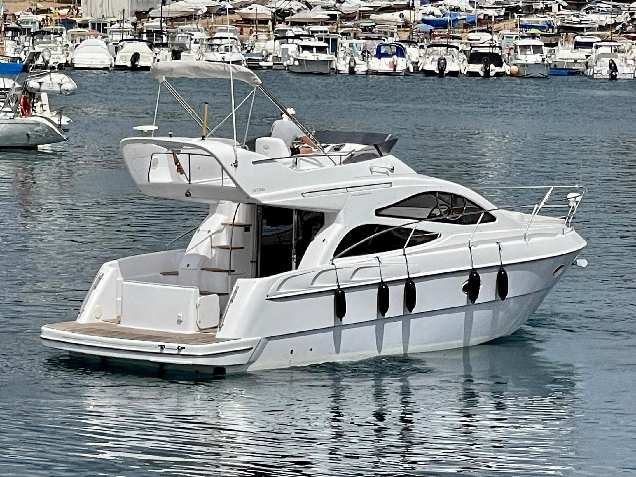 2006 Genesis Boats 37 Flybridge yacht on calm water, surrounded by other boats.