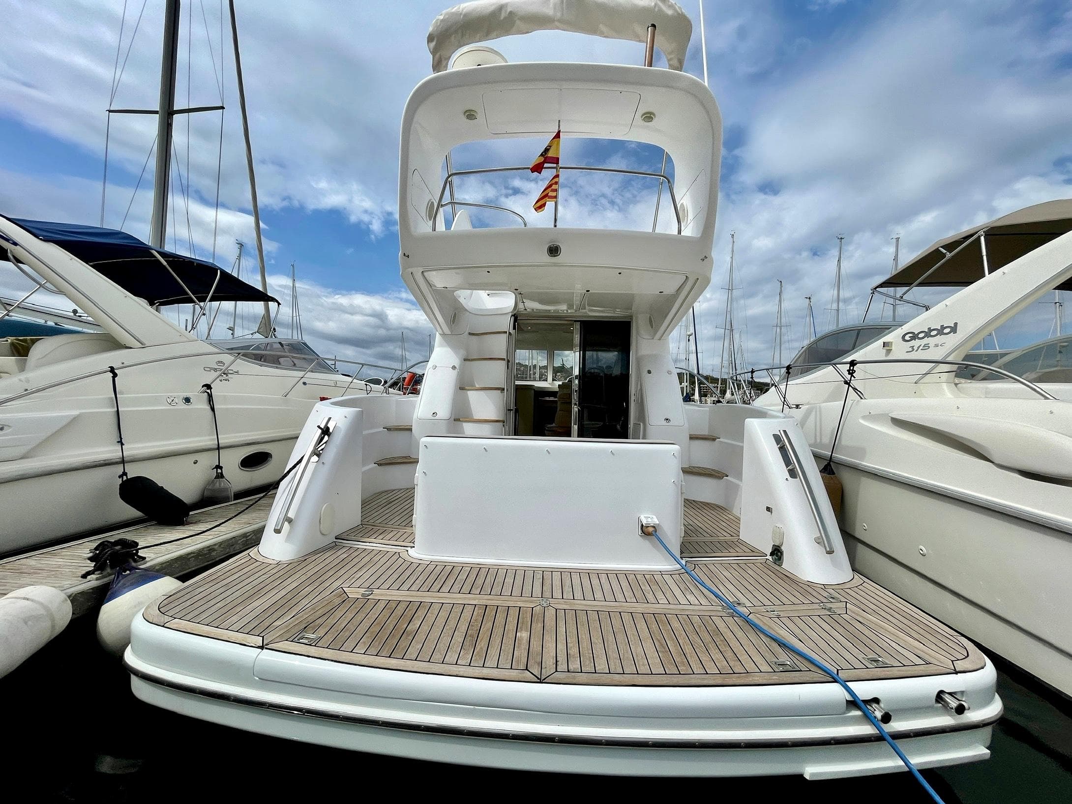 2006 Genesis Boats 37 Flybridge docked, showcasing spacious deck and sleek design.