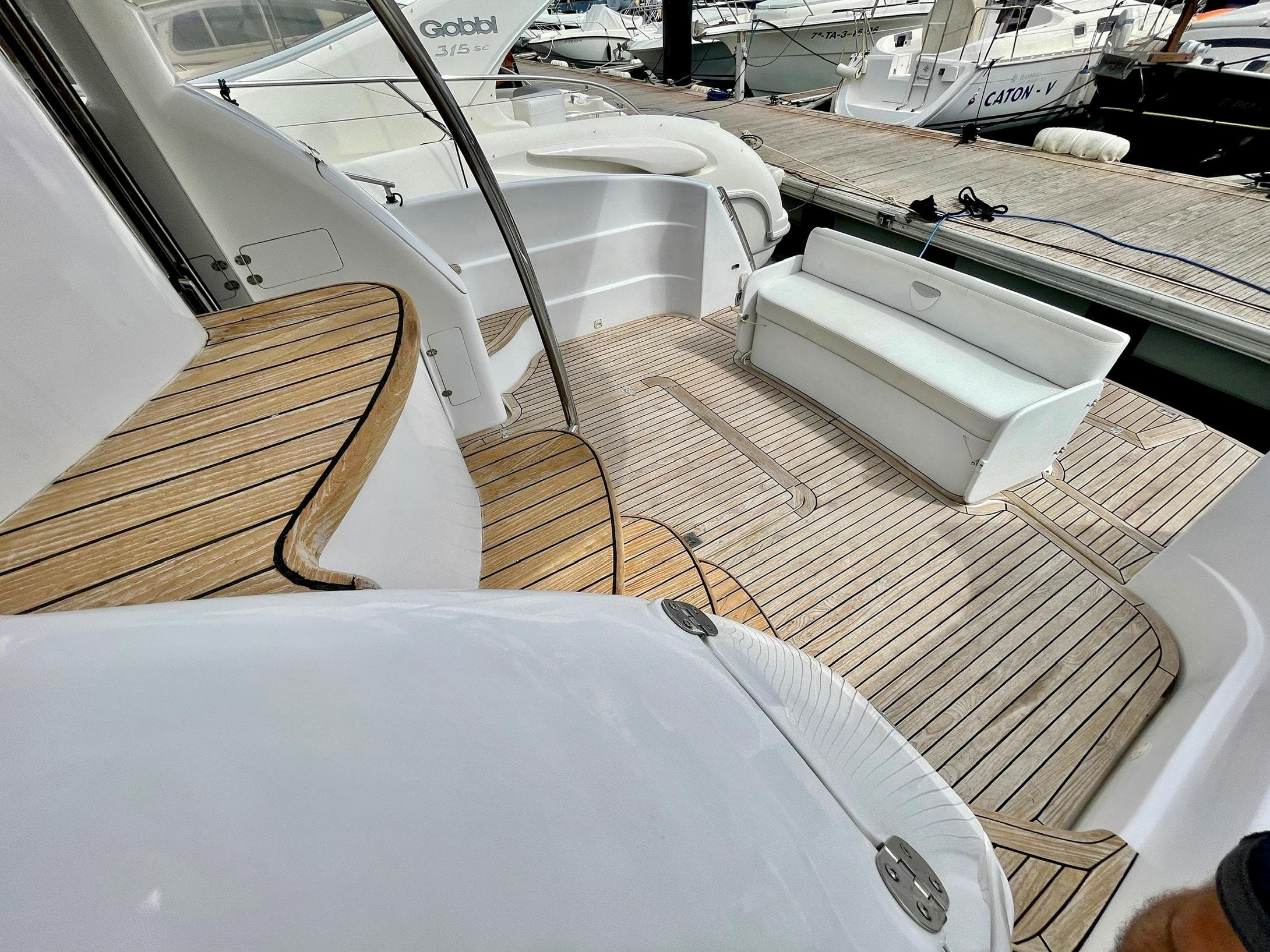 Luxurious Genesis Boats 37 Flybridge 2006 with elegant teak deck and seating area.