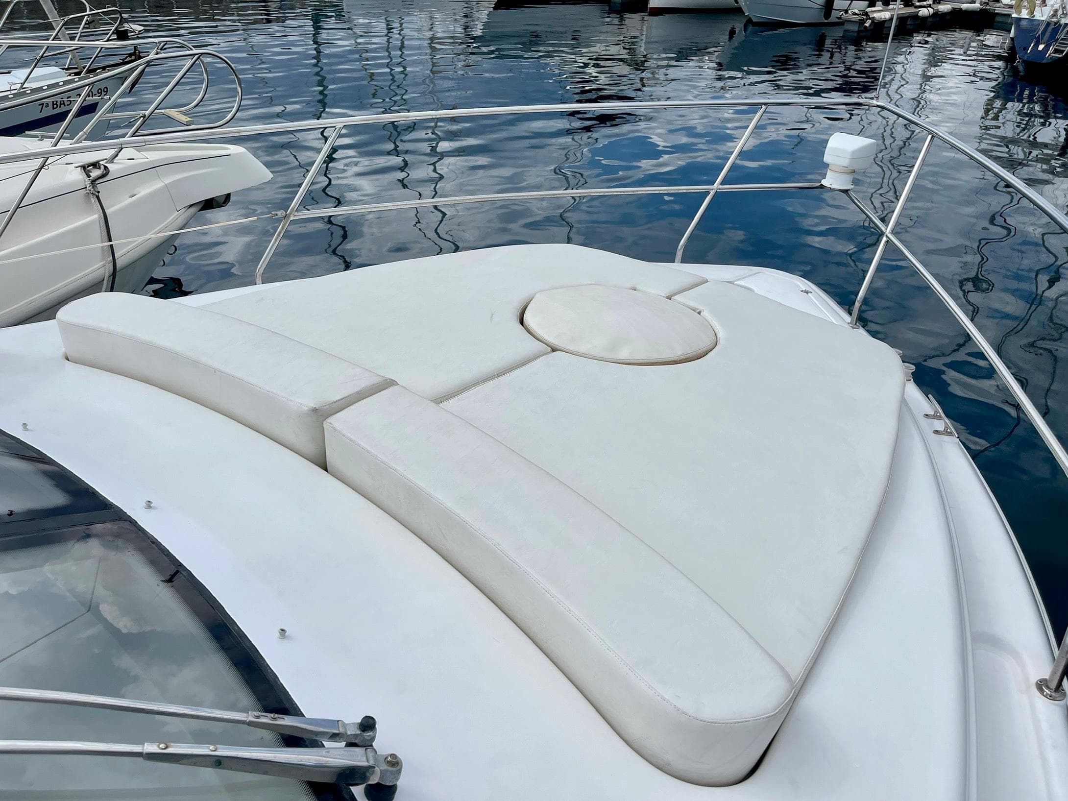 2006 Genesis Boats 37 Flybridge with white cushioned deck, docked in marina.