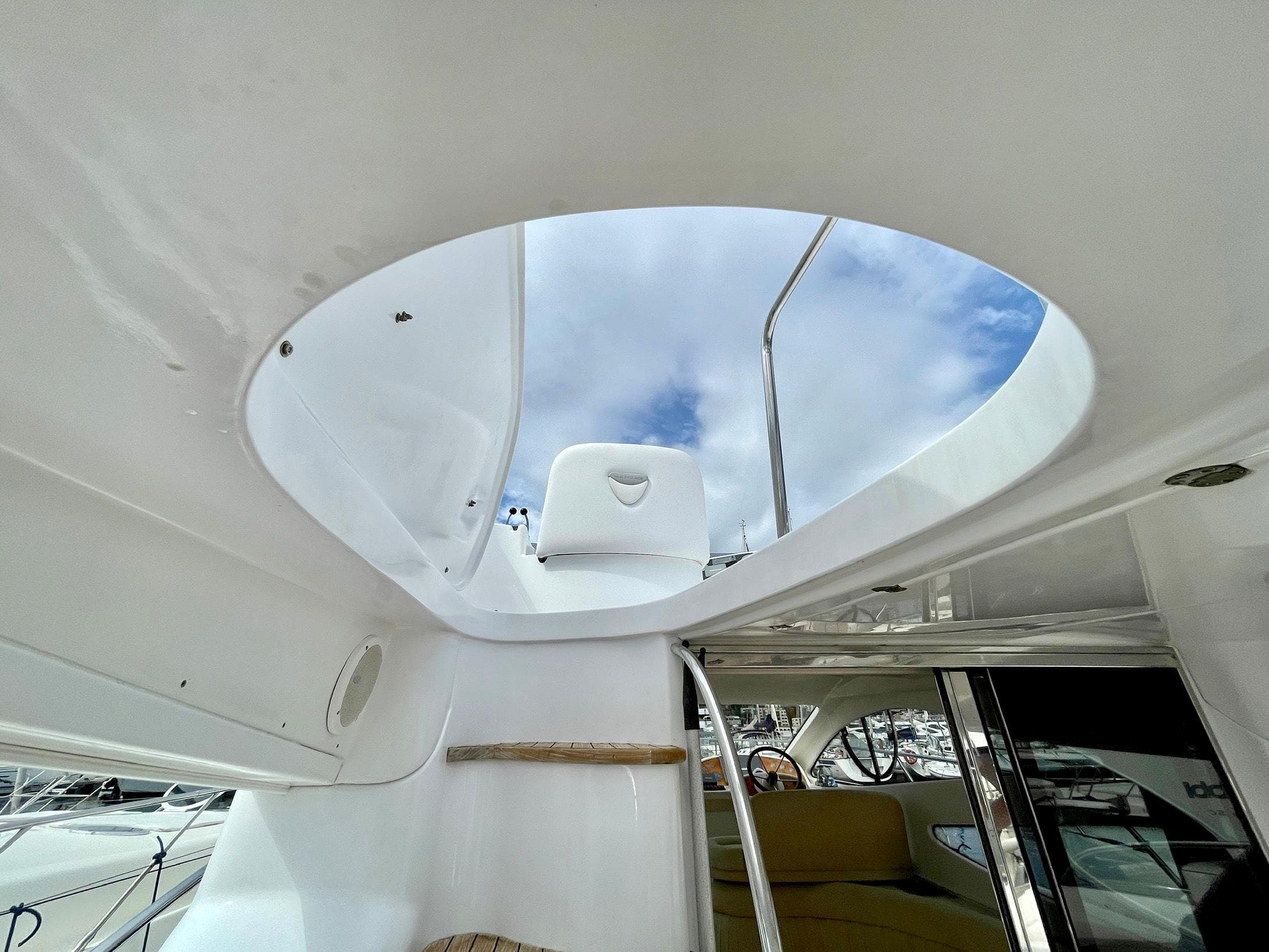 Interior view of 2006 Genesis Boats 37 Flybridge, showcasing open hatch and sky.